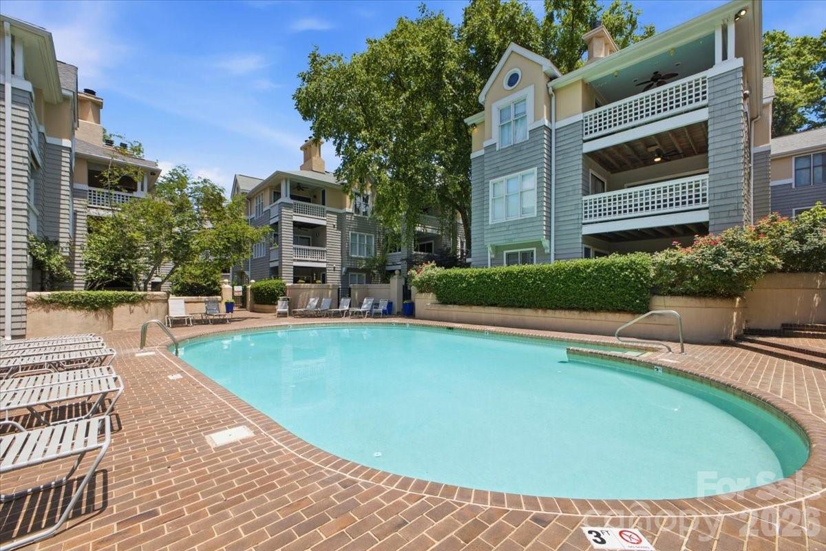 A beautifully maintained two-bedroom, two-bath condo on Charlotte's iconic Queens Road! The convenience of city living meets the charm of a quiet, tree-lined community. As a desirable first-floor residence, the home offers a spacious layout, beautiful surroundings, and a prime location. 

A cozy wood burning fireplace anchors the spacious living area that is flanked by large sliders for optimal natural light. Boasting an open floor plan with an unbeatable location and thoughtful community amenities, this condo offers the best of connected living. With the convenience of single-level living, the front entrance overlooks the manicured courtyard. The private rear patio is steps from the community pool—close enough to enjoy and positioned to provide privacy. This setting is rarely found so close to the city!

Enjoy quick access to places like Uptown, Trader Joe's, Metropolitan Target, and other popular neighborhoods while nestled in an established residential setting. Tucked away from the city's hustle and bustle, mature trees and beautifully landscaped grounds create a welcoming atmosphere in a lovely community. If you are looking for convenience, comfort, and community, you’ll find it here. This condo delivers!
