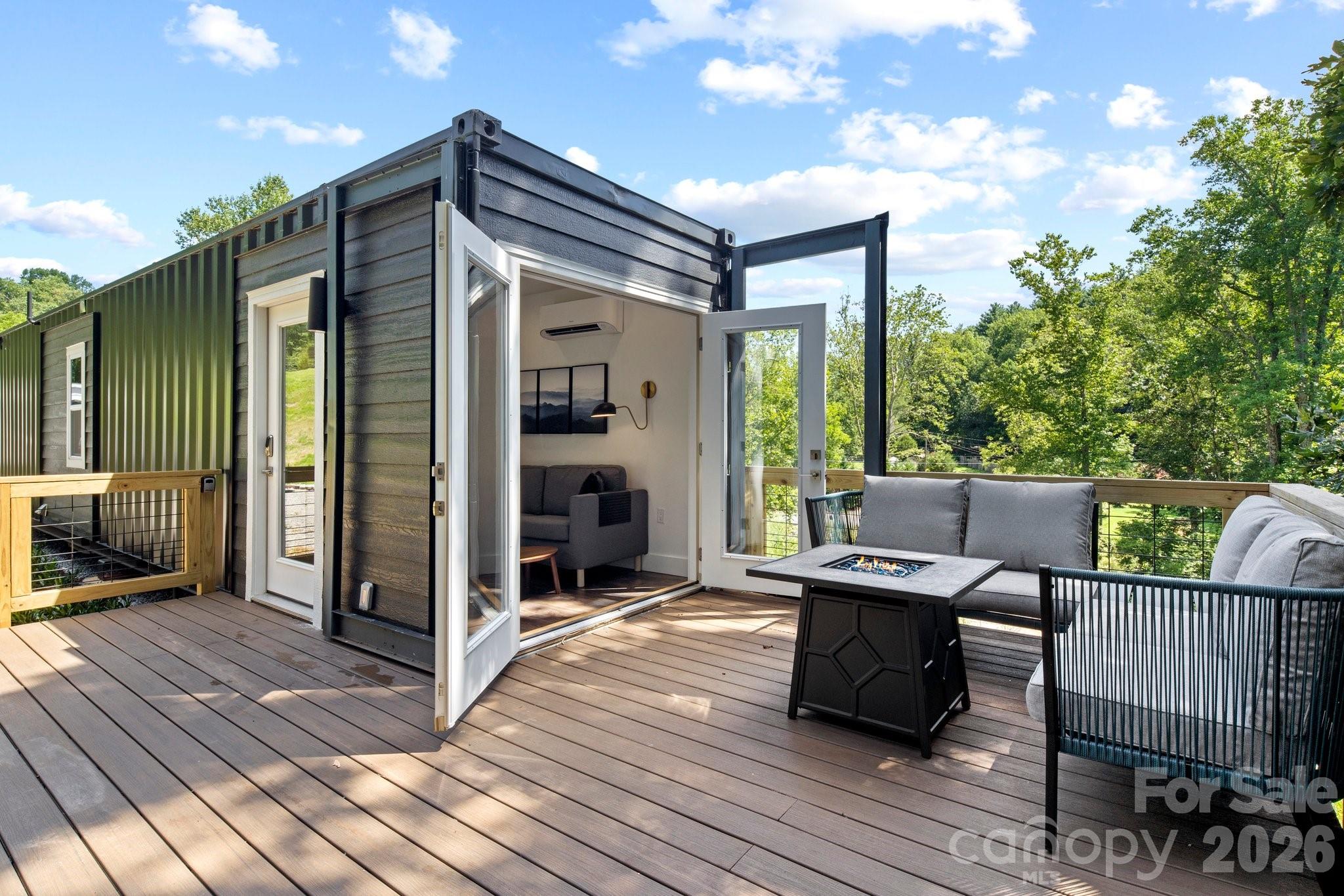 Own a rare modern container retreat just minutes from Asheville—featuring two designer tiny turn key homes, Pearl and Onyx, offered together for a unique lifestyle or investment opportunity.

Pearl and Onyx Container Homes present a distinctive chance to own two thoughtfully designed modern container retreats in one offering. Each stylish tiny home blends contemporary design with efficient, low-maintenance living, creating an experience that appeals to both personal use and short-term rental guests.

Both homes feature a comfortable queen bedroom, a sleek kitchen with essential appliances, and a beautifully maintained full bath. Outdoor living is a standout feature, with spacious decks ideal for relaxing, entertaining, or enjoying the surrounding mountain setting. Each home also includes a private bedroom deck—perfect for morning coffee or evening stargazing.

Positioned just minutes from the vibrant dining, shopping, breweries, and outdoor adventures that make Asheville such a sought-after destination, these homes provide a memorable retreat for visitors and owners alike.

With two separate homes included, this property offers exceptional flexibility—ideal for buyers seeking a dual short-term rental investment, a live-in-one rent-the-other scenario, or a private mountain compound for friends and family.

Unique, stylish, and perfectly located near Asheville’s thriving tourism market, Pearl and Onyx deliver a rare opportunity to own a turnkey container home portfolio in the heart of Western North Carolina.