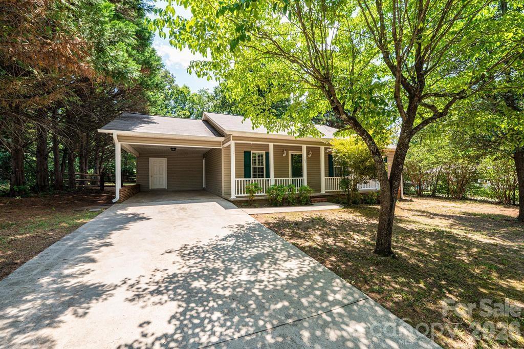 What a cute house!  And walking distance to downtown Hudson!  Did you know downtown Hudson is undergoing capital improvements that will include expanded sidewalks and a covered pavilion, among other things?  Located on a nice level lot with plenty of mature shade trees, this home offers use of every single square foot of space!  Three bedrooms, 2 full baths, living and dining rooms!  The dining room area would also make a great home office space. Front AND back porches.  The back porch is awesome!  Big enough to entertain on with your own big screen TV and good size couch!  And the front porch ... wide enough for a swing and some rocking chairs!  Off of the carport is a good size storage area to store bikes and yard work equipment!  Roof and gutters replaced in 2023!  Come take a look!