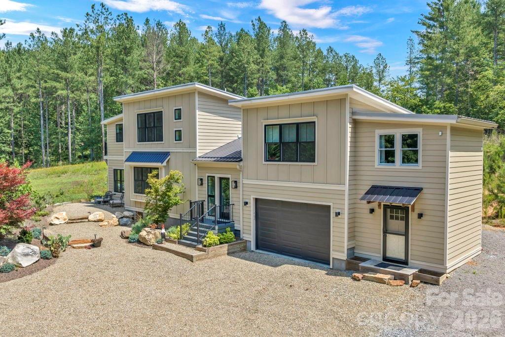 This 74.06-acre unrestricted property features long-range mountain views, Canoe Creek running the length of the property with several access points to the water, and approximately 2 miles of hiking and 4wheeler trails for enjoying your private mountain sanctuary. It includes a 2,351 sqft 3BR, 3BA 2story home built in 2020 along with multiple other potential build sites throughout, and an open, grassy field perfect for picnics, bonfires and recreation. The property sits across the street from the 652 acre Oak Hill Community Park and Forest which hosts over 20 miles(and growing) of mountain biking and hiking trails. Lake James and Lake James State Park are less than 15 mins away for water sports, hiking and more mountain biking for adrenaline enthusiasts.  The towns of Old Fort, Black Mountain, Boone, Blowing Rock and Asheville are all less than an hour's drive from the property.   Historic downtown Morganton which offers shopping several grocery stores, restaurants, breweries and wineries is just 10 minutes away by vehicle; Enjoy the Historic Morganton Festival in September, the TGIF series that runs from May through July and the Winter Carnival and Downtown Lighting to start the Christmas holidays; These 74 acres offer a blend of privacy, natural beauty and development potential while remaining pristine and with breathtaking views; This is the perfect setting for your own private estate, a family compound, a hunting property, an eco-tourism venture including camping and glamping, an AirBnB or as a legacy investment; Explore the remaining foundation of the old JD Pitts Dam and Mill site on the property in Canoe Creek where grain was milled using the dam, water wheel and grinding wheels; Game on the property include deer, turkey, rabbit, dove, and an occassional bear, and more; The custom-designed, like-new 2story home has a 1st floor bedroom and full bathroom, an open layout and 2 primary and secondary owner's suites; The entry room has 2 closets and a vaulted, shiplap ceiling; The kitchen has a wonderful view of the backyard landscaping and hill along with a large island and stainless appliances; The dining room has a comfortable window seat and a table made from local harvested wood; The living room has plenty of natural light coming in and a sliding glass door to the spacious, covered rear deck with its wood stove; The left side owner's suite has an office area and balcony, a loft area, the laundry and a full bathroom with a tiled and glass stall shower; The right side owner's suite with its own private access and stairway has a large walk-in closet / office and a full bathroom with a stall shower; Other desirable features include a 1st floor workstation, shiplap walls, wood laminate planking and ceramic tile flooring, a hot tub and 2 mini-split heat/air units with 5 trunk lines; The outdoor space includes a landscaped front natural area, a fire pit and backyard access to the trail system; The attached garage and attached storage area give you valuable storage area; The detached garage has electric, a concrete floor and a rear lean-to perfect for a tractor or side-by-side; The property was accepted in March 2026 to the NC Present-Use Value program which provides tax incentives to the property owner;