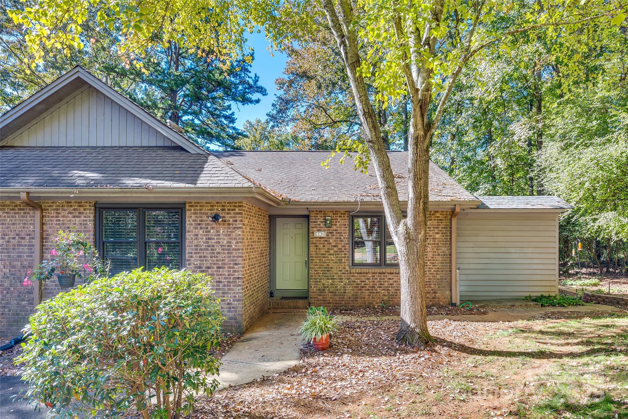 Discover this end-unit condo featuring 2 bedrooms and 1 bath. This home offers a spacious foyer and dining area, large family room with wood floors. Kitchen has ample cabinetry and includes stainless steel appliances.Enjoy your meals in the dining area, breakfast nook, or on the oversized private deck, perfect for relaxing while overlooking the wooded view.

The laundry room is equipped with a washer, dryer, and plenty of cabinets for storage. The over-sized bathroom provides generous counter space and a large walk-in shower with a bench seat. With HOA fees covering trash, exterior maintenance, and lawn care, maintenance-free living is at your fingertips. Ideally situated near I-77, Charlotte Douglas Airport, Carowinds, shopping, and dining, this condo is a must-see!