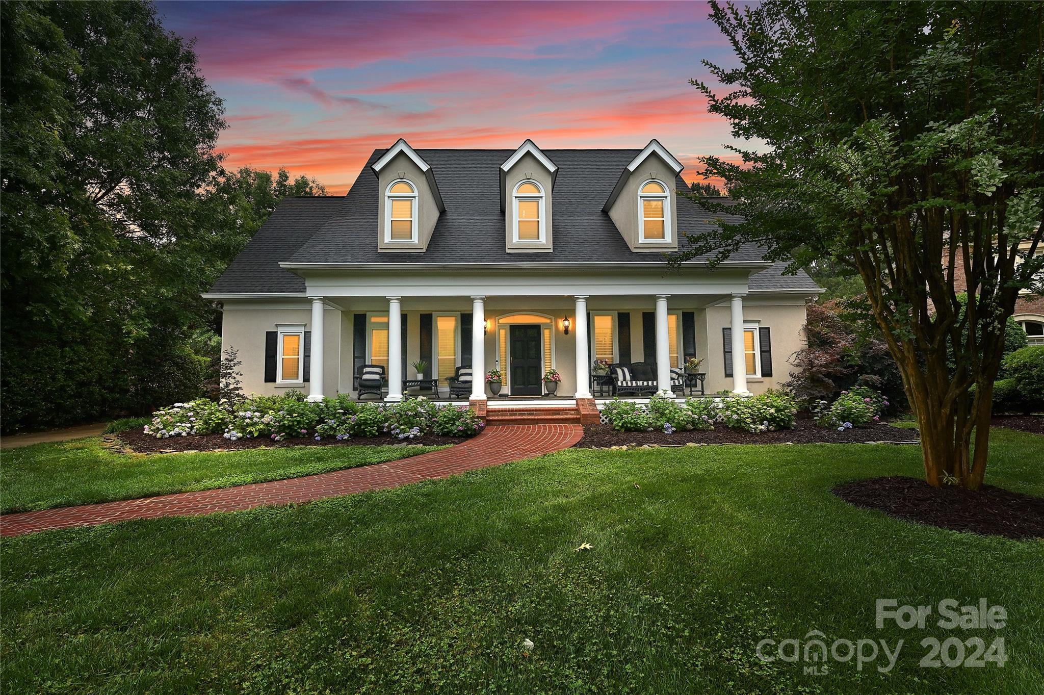 Stately Low Country home in Ballantyne Country Club boasts a "Southern Living" front porch & back veranda, perfect for outdoor living! The interior features a Dining Room w/beautiful millwork, kitchen w/white cabinetry & quartz countertops, subway tile backsplash, SSTL appliances, & updated lighting. Brkfst area & Grand 2-story Great Room w/Fireplace & custom built-ins. Beautiful hardwoods, vaulted ceilings, french doors, plantation shutters, front & back stairs & skylights flood the home w/natural light. Primary on main w/large bath & HUGE custom closet. Laundry convenient to backload garage entry w/Drop Zone. 2nd FL:3 bdrms w/walk-in closets, two white tiled baths. WOW-office OR 5th bedroom w/built-in workspace AND huge BONUS! Large PRIVATE yard, seasonal colorful landscaping-classic design! Ideal for those who appreciate comfort & style. New bdrm carpets, refinished hdwd floors, freshly painted. Stunning presentation-this home is designed for family time and engaging entertainment!