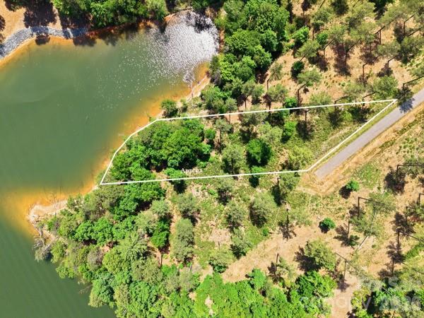 Tucked inside the gated community of Lakeside Reserve, Lot 89 at 2960 Jumping Run is the kind of property that makes you pause for a second… because this is why people move here.

This is a true lakefront homesite on Lake Rhodhiss, offering the opportunity to build a home where the view isn’t just part of the experience—it is the experience. Picture mornings on your back porch with coffee in hand, watching the water instead of your phone. Afternoons spent kayaking straight from your backyard. Evenings where the sun drops over the lake and everything just slows down.

Lakeside Reserve is known for its peaceful, tucked-away feel, where nature leads and noise takes a back seat. It’s the kind of place where weekends aren’t filled with errands—they’re spent on the water, by the fire pit, or hosting friends who suddenly want to visit a lot more often.

And while it feels like a true escape, you’re still connected. Charlotte is about an hour away, making it easy to head in for work, dining, or a game—and then come home to quiet. Nearby towns like Hickory and Morganton give you everyday convenience without the traffic and pace of a larger city.

This lot gives you the flexibility to build exactly what you want—whether that’s a full-time lake home, a second home, or a long-term investment. Room for outdoor living, space to create your own dock (per community guidelines), and a setting that simply doesn’t get old.

If you’ve been searching for a place where life feels a little slower, a little quieter, and a lot more intentional—this is it.

Lake life starts here.
Water provided by Icard Township Water Corp (community system). Septic required. Lot is sloping so it could support a basement or high crawl space when building.