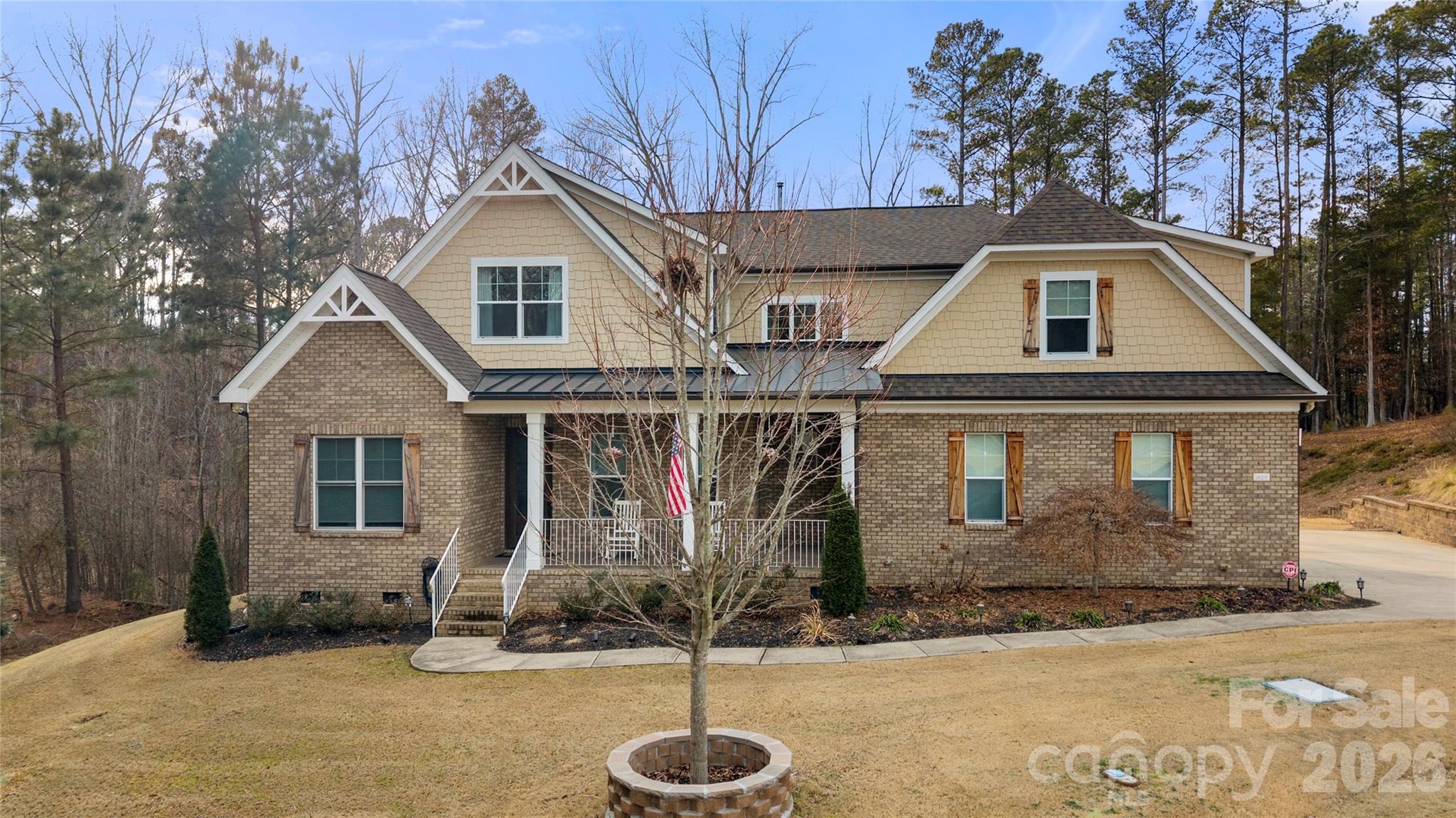 Beautifully crafted country-style home with manicured landscaping and a deep rocking-chair front porch that welcomes you in. This custom-built residence is filled with thoughtful details, including coffered ceilings in the great room and a stunning stone fireplace that anchors the space. The gourmet kitchen features glass-front custom cabinetry with interior lighting, a granite-topped island, classic subway-tile backsplash, and a gas cooktop perfect for everyday cooking or entertaining.

The main-level primary suite offers a true spa-like retreat with a frameless walk-in shower cave and multiple shower heads. Also on the main floor is an office and two additional bedrooms connected by a Jack-and-Jill bath, providing flexibility for family or guests.

Upstairs, you’ll find a bonus room and an additional bedroom ideal for guests, hobbies, or a media space. Step outside to an entertainer’s paradise with incredible outdoor living areas, including a two-tier deck and a screened porch with all-season doors that open directly to the great room, creating seamless indoor-outdoor flow for gatherings and backyard barbecues. This exceptional home blends custom design, comfort, and timeless charm in a setting made for relaxing and entertaining.