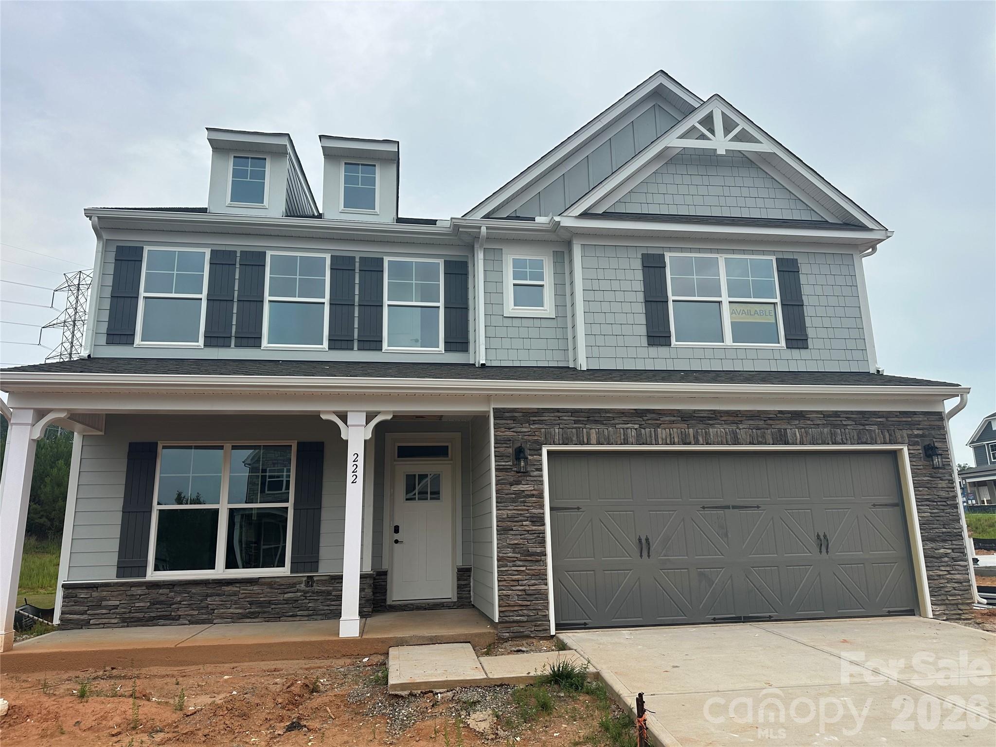 Brand new construction in an amenity-rich community less than two miles from Lake Norman! This 2-story Davidson plan has 5 bedrooms, 3 full baths, and more than 3,000 square feet of living space. The kitchen features grey cabinets, quartz counters, tile backsplash, a stainless range hood, and stainless appliances, including a gas cooktop. The same design carries through to the butler pantry, which also has a built-in wine refrigerator. The main floor also includes a guest bedroom, a full bathroom with a 4-ft shower with bench seat, dining room with tray ceiling, mud room with drop zone, and family room with gas fireplace. The upper floor has the primary suite with a luxury shower, three secondary bedrooms, a full bath, loft, and laundry room. Other extras include foyer with tray ceiling, soft-close cabinets, and stairs with composite treads & metal balusters. Community amenities include a pool, cabana, pickleball courts, and pocket parks. Find out more today!