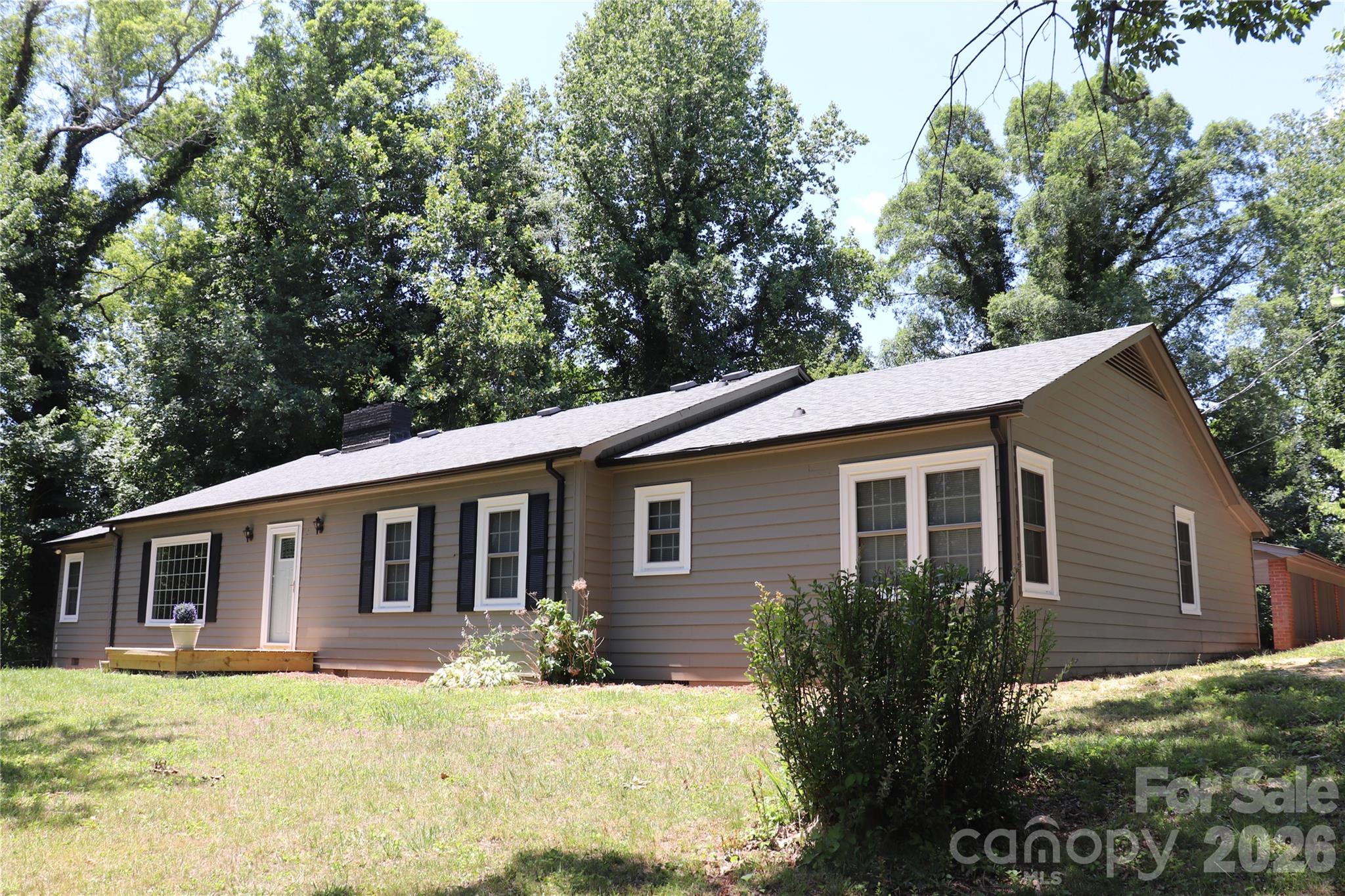 Lovely 3-bedroom, 2-bath home in Northwest Lenoir offering 2,298 square feet of comfortable one-level living and numerous updates throughout. A welcoming foyer with abundant closet space opens to a spacious living room featuring a fireplace, built-in shelving, and an abundance of natural light, with an adjoining dining room ideal for entertaining. The remodeled kitchen is equipped with solid-surface countertops, an electric range, range hood, and dishwasher, and opens seamlessly to a cozy den highlighted by wormy chestnut walls and a second fireplace. Two bedrooms share a convenient Jack-and-Jill bath, while the third bedroom enjoys easy access to the hall bath, which also includes a washer and dryer. Updated bathrooms feature stylish vanities and tile finishes. At the rear of the home, a bright sunroom leads to a covered patio, utility room, and an oversized 28' x 26' double carport. Additional features include beautifully refinished hardwood floors, vinyl flooring in the kitchen, den, and sunroom, tile flooring in the bathrooms, and a carpeted flex room off the living room that would make an excellent office, study, or formal dining room. Both the interior and exterior have been freshly painted. A partial unfinished basement, accessible from both inside and outside the home, provides excellent storage. Schedule a tour today!!!