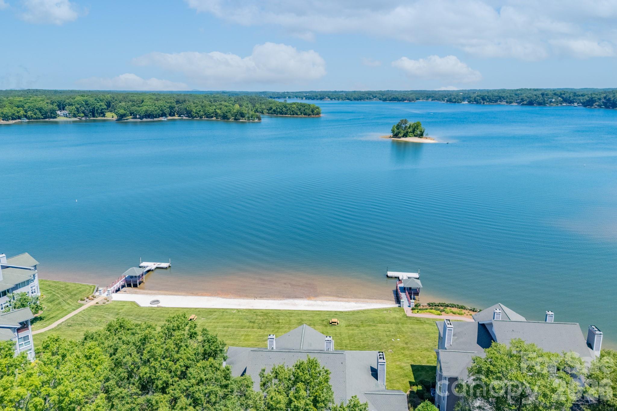 Welcome to Lake Club. Come experience this rare, resort style community on the banks of Lake Wylie. 703 Lake Club is a must see! A true turn key property. High-end finishes & 10ft ceilings throughout. The open floor plan is great for entertaining. Oversized windows provide an abundance of natural light and views of the lake. Large kitchen with island, SS appliances, granite countertops, large pantry, roll out shelving & bay window. The expansive lake views in the primary feel like you're living on vacation. The sunroom is great anytime of day, anytime of year. Take advantage of the recent upgrades; remodeled primary & secondary bathrooms, whole home paint, replaced all light fixtures, added motorized curtains in living room & primary bedroom, replaced sunroom fan, replaced & tinted 5 window panes, converted 3rd bath to walk-in storage. (Plumbing still intact if desired) All of this plus the community amenities of the pool, sandy beach, fire pit, floating docs, canoe/kayak launch, playground, tennis and two covered piers with grills. NO STEPS to get into or inside the unit. Conveniently located next to the beautifully renovated Ebenezer Park & RH airport. Marina next door offers boat slip rentals. Come take a look today! Showings to begin, Friday (5/22) at Noon.