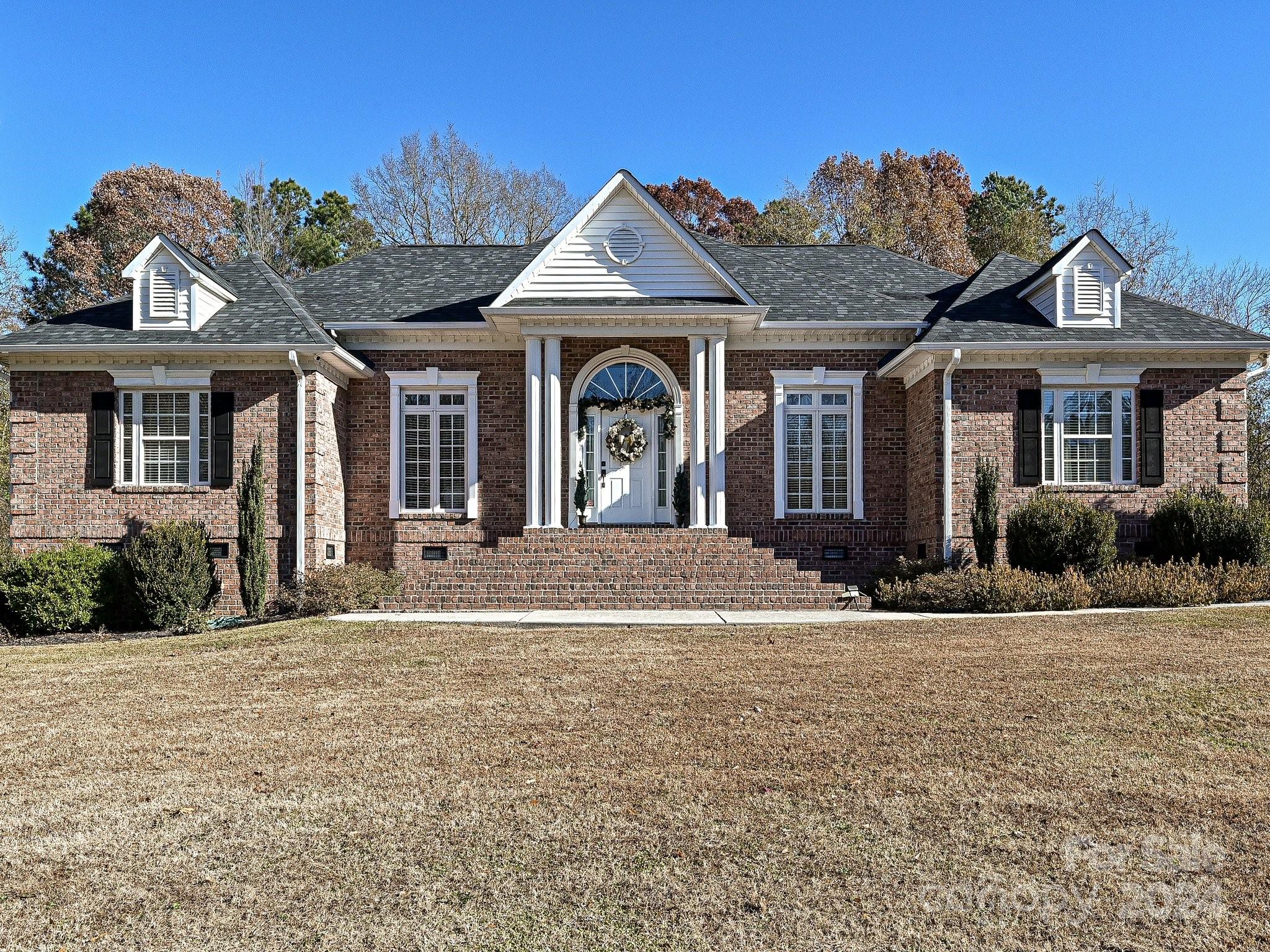 This all brick home has it all. Beautiful hardwood floors in foyer opening into a large living room that also features fireplace with gas logs, trey ceiling, french doors that lead to a screen porch overlooking a large L shaped pool. Formal dining rm has hardwood floors. Kitchen has been updated with new cabinets, appliances, quartz counter tops and ceramic backsplash. Flooring in kitchen, breakfast area and laundry room is ceramic tile. Large primary bedroom has trey ceiling, hardwood floors. Large primary bath, with double vanities separate shower and whirlpool tub, large walk-in closet. There are two additional bedrooms with jack n jill bathroom. And an additional bedroom and bath.  All bedrooms feature beautiful hardwood floors. Outside you can enjoy the large swimming pool, screen porch. There's also a oversized double garage with additional storage. The pictures don't do it justice, it's a must see.