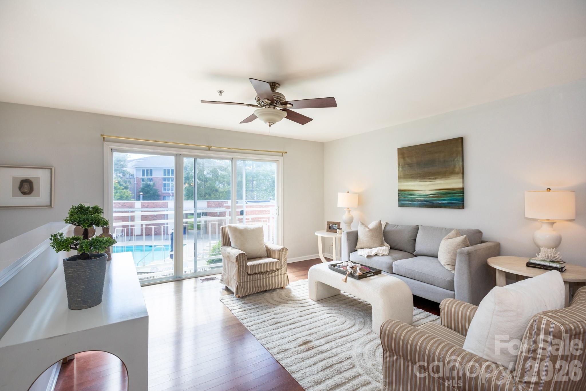 Value and convenience in this stylish Noda condo, complete with a coveted attached garage. No communal hallways here: simply walk right in and enjoy the comfort of home. The main level features an open, light-filled layout with sliding doors overlooking the community pool. The spacious living area flows seamlessly into the dining space and kitchen, which offers updated appliances, a pantry, and a full laundry room. A guest powder room is tucked nearby, along with the roomy primary suite featuring a walk-in closet and an en-suite bath with dual vanity. Downstairs, you’ll find a second generously sized bedroom with its own en-suite bath and sliding doors that open to a terrace. The lower foyer connects directly to the 244 sq ft attached garage — a unique layout in this community. All this is just a short stroll to NoDa’s vibrant dining, shopping, arts scene, the light rail and a new Sprouts grocery store. Easy living meets unbeatable location. Welcome home!