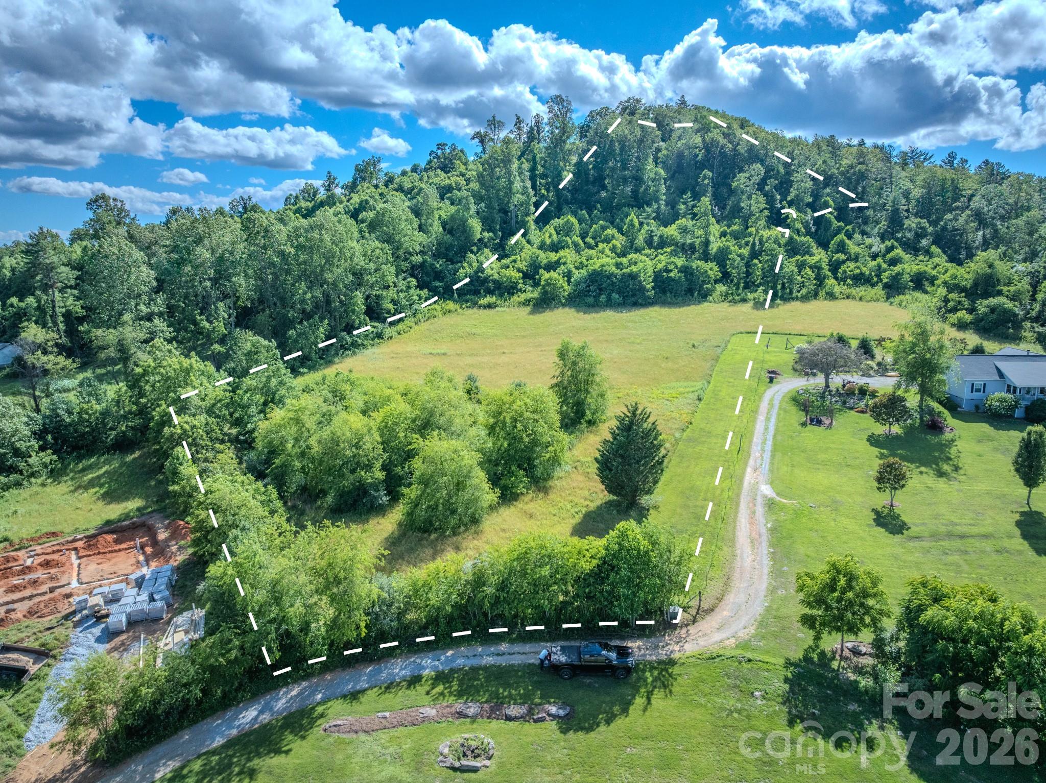 Now offered together, Lots 5 & 7 provide a combined 8.15 acres on Rocky Hill Drive in Hendersonville, offering an excellent opportunity to build your mountain retreat or family estate. Located just 8 minutes from the intersection of US Highway 64 and Interstate 26, the property offers convenient access to everyday amenities. Ingles, Walmart, Sam's Club, Chick-fil-A, and numerous restaurants and shopping options are only 7 minutes away. Downtown Hendersonville is approximately 10 minutes away, while Asheville is just 30 minutes to the north.

Rocky Hill Drive is a privately maintained gravel road with a recorded road maintenance agreement. Utilities include underground power provided by Duke Energy and high-speed internet from AT&T. A private well, septic system, and propane will be needed.

The property is zoned Henderson County R2-Rural, allowing one dwelling unit per acre. Approximately 2.85 acres are gently sloping, already cleared, and ready for development, while the remaining wooded acreage features steeper terrain with outstanding long-range northern mountain views.

Contact the listing agent for recorded plats, deeds, disclosures, interactive 3D maps, and additional property information. Opportunities like this don't come around often! Properties offering these views at this price are rare, making this a chance you won't want to miss.