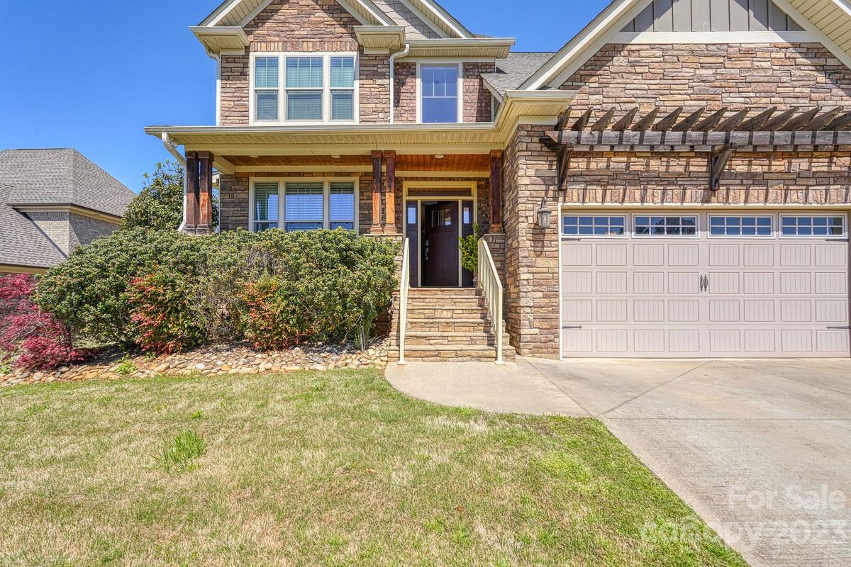 Welcome to your dream home located in the prestigious Woodfin Ridge community at 341 S Woodfin Ridge! This stunning property boasts 4 spacious bedrooms, 3.5 bathrooms. and also includes a large media room! This home has an inviting open floor plan, while the the living room features a cozy fireplace, hardwoods coffered ceiling and wainscoting. The chef's kitchen is fully equipped with GE stainless steel appliances, granite countertops, tile backsplash, and plenty of storage space. The primary master suite on the main level is a true oasis, complete with a sitting room and an additional fireplace, luxurious en-suite bathroom featuring a soaking tub, separate glass tiled shower, dual vanities plus large closets. The remaining bedrooms are also generously sized.  Out back you will find lots of privacy and a screened in porch and patio! Enjoy access to all the amenities that Woodfin Ridge has to offer. Don't miss your chance to make this stunning property your forever home!