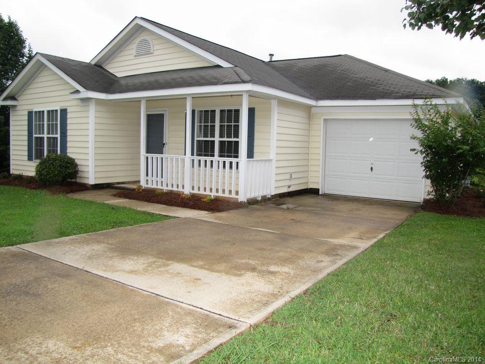 A welcoming rocking chair front porch invites you inside this adorable 3-bedroom, 2-bath ranch. Features include vaulted ceilings, great natural light, and ceramic tile and hardwood floors. The kitchen has an island, and is open to the breakfast area. Sliding doors access the deck, which overlooks the fenced back yard. Minutes to shopping, dining, US-74 and US-601.