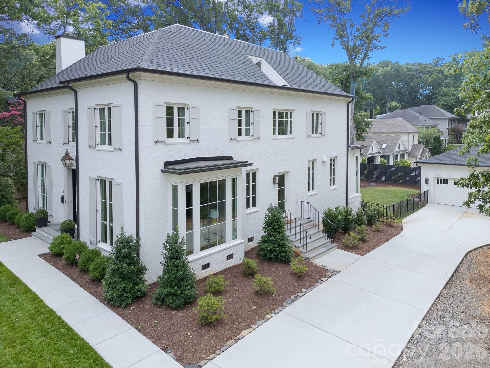Exceptional 2022 build by Whittington Builders, thoughtfully designed by Greg Perry and located on a quiet block in the heart of Cotswold. Offering timeless style, high-end finishes, and beautifully designed living spaces. A gracious foyer opens to elegant dining and living rooms. As you would expect, the chef’s kitchen is amazing: custom cabinetry, premium appliances and a wet bar/butler’s pantry contributes to easy living with second built-in refrigerator, dishwasher & ice maker.  Friend's side entrance, mud room w/ built-ins adds function and style. Light-filled family room and separate breakfast area open to a covered bluestone porch with fireplace and a flat, fenced backyard. A private study tucked between main living spaces offers flexible uses. Upstairs features primary suite, three secondary en suite bedrooms, and laundry. The third floor offers a bonus room, 5th bedroom, full bath, flex space, and conditioned storage. All just minutes from Uptown, SouthPark, and Plaza Midwood.