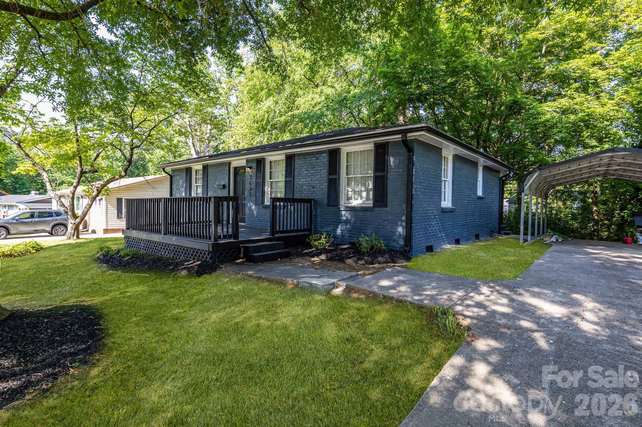 *THIS HOME QUALIFIES FOR 100% FINANCING, $15,000 RATE BUY DOWN, UP TO $5,000 IN CLOSING COSTS & NO PMI!!* Stylishly updated 3 bed 1.5 bath loyal blue brick single story home in the highly-coveted & well-appreciating area of Shamrock Hills. Your new home boasts many improvements, including newer roof (2024), hot water heater (2024), new six panel doors, new LVP flooring & complete interior + exterior paint overhaul. Primary bedroom features an en-suite half bath, providing that extra bit of privacy & convenience for the new owner. Full bath is conveniently central to all three bedrooms & includes a new vanity & direct-to-stud alcove tub w/ wall surround. Kitchen is well-suited for every culinary endeavor, upgraded w/ sleek granite counters, SS appliances, plenty of new cabinetry & subway tile backsplash that completes the space. Rear kitchen door opens to a large, shaded backyard w/ mature trees, great for BBQing, gardening, or entertaining family & friends during the warmer Charlotte months. Detached carport provides that extra bit of parking protection & convenience. In a phenomenal area at one of the most competitive prices to hit this area's market, don't miss your opportunity in touring 3637 Glenville!!