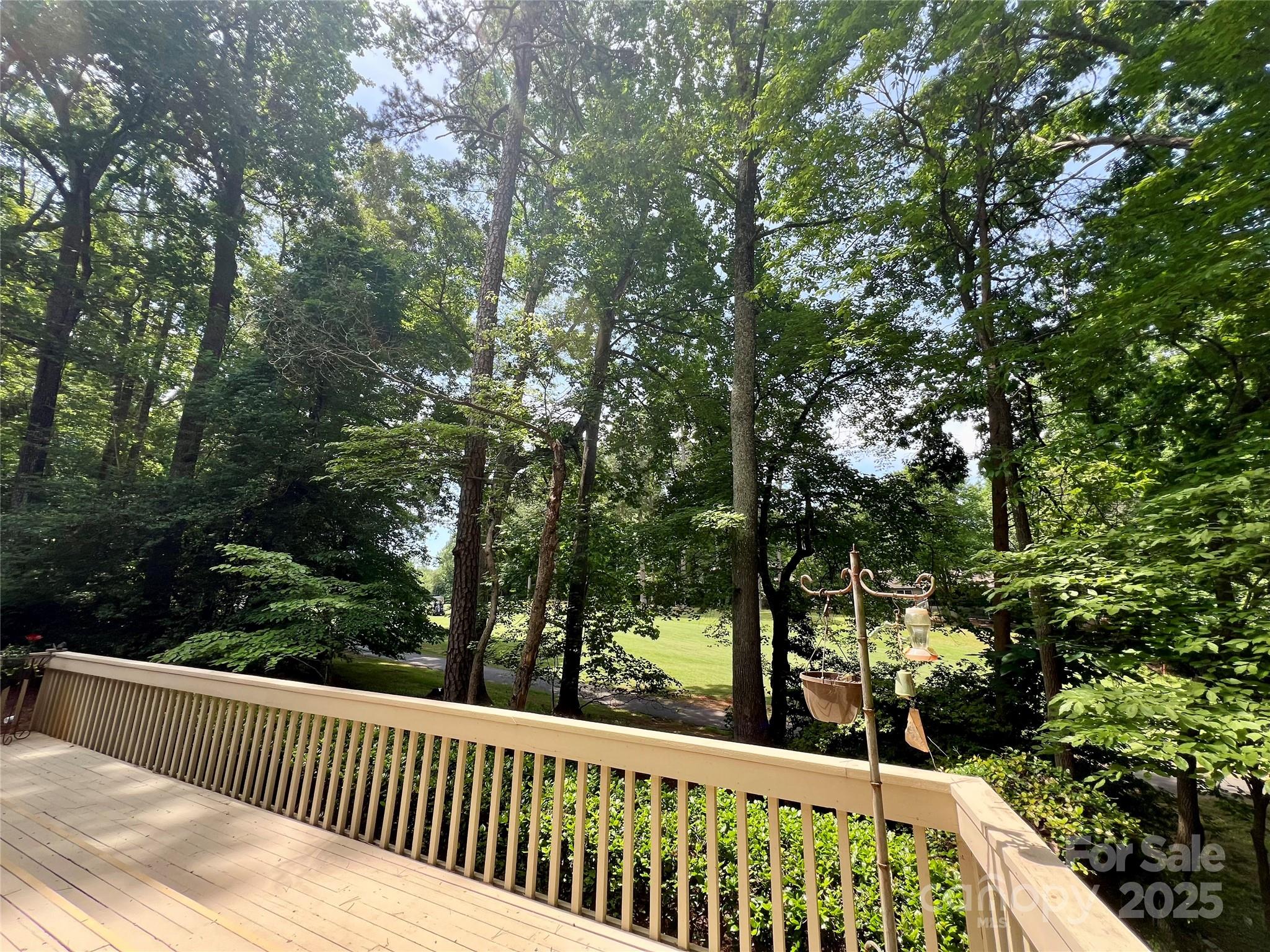 Welcome to this stunning ranch home in the coveted, amenity-rich community of River Hills with 24/7 gated security. Perfectly situated on nearly half an acre along the golf course, the property offers the ideal combination of scenic views and natural privacy. Enjoy true outdoor living with a wraparound porch that spans the entire back and sides of the home—perfect for relaxing or entertaining. Inside, you'll find soaring cathedral ceilings and floor-to-ceiling windows that flood the open-concept living space with natural light, creating a dramatic and inviting atmosphere. The layout is both functional and stylish, offering spacious living areas and seamless indoor-outdoor flow. Each of the 3 spacious bedrooms includes a private en-suite bath, delivering comfort and privacy throughout. This home offers the perfect blend of luxury, lifestyle, and location in one of Lake Wylie’s most desirable communities.