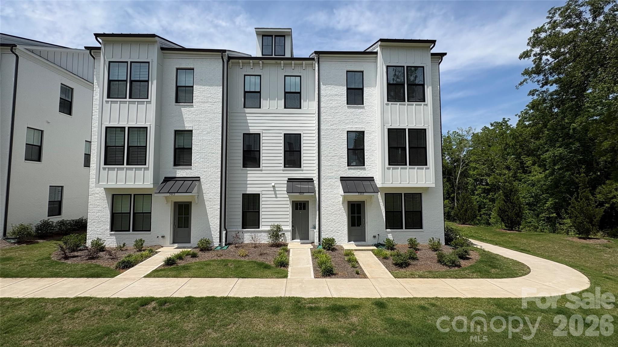 Stunning 3-Story Townhome in Highly Desirable Alexander Providence. Welcome to this beautifully maintained 3-story townhome located in the sought-after Alexander Providence community—just minutes from premier shopping, dining, and everyday conveniences along Providence Road. 

Upon entry from the rear-load garage or Covered front Entry, you’re greeted by a versatile first-floor bedroom or private home office with Ceiling Fan with ensuite full bathroom—ideal for guests or remote work. The bottom floor is covered with Luxury Vinyl Plank Flooring. 

The second level features an inviting open-concept layout designed for modern living and entertaining. The kitchen is the centerpiece, showcasing a spacious island, stainless steel appliances, Refrigerator included, and ample cabinet space, seamlessly flowing into the dining area and great room. Step outside onto the second-floor deck—perfect for morning coffee or unwinding with a good book. Luxury Vinyl Plan Flooring covers the entire 2nd floor.

Upstairs on the third level, retreat to the spacious primary suite featuring dual closets and a luxurious en-suite bathroom with dual vanities, a tiled walk-in shower, frameless glass enclosure, and built-in bench. An additional guest bedroom also offers its own private en-suite bath with a tub/shower combination. For those who own electric vehicles, Owner has installed a plug into the garage for Electric Vehicle Charging - Bring your own Charger. 

This townhouse offers the perfect blend of comfort, style, and location. Schedule your showing today—this one won’t last!