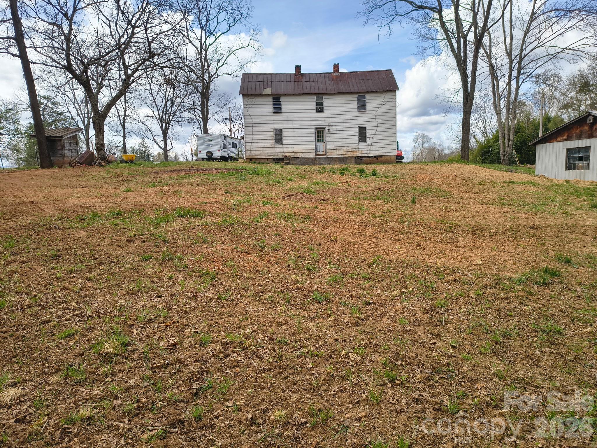 Opportunity awaits at this historic home in Clyde, North Carolina, offering a chance to restore, renovate, and customize a property with character and potential. Originally built in 1900, this two-story residence features approximately 1,528 square feet with 3 bedrooms, 1 bathroom, and sits on a spacious lot of nearly 0.8 acres in the scenic mountains of Haywood County.

Significant preliminary work has already been completed, providing a head start for renovation plans. Much of the original plumbing has been removed in preparation for future upgrades, while the bathroom plumbing remains in place. The property is connected to city water and also includes an on-site well, offering additional utility options for future improvements.

A detached powered shop/garage provides valuable space for storage, hobbies, equipment, workshop use, or renovation projects. The generous lot offers room for outdoor living, gardening, landscaping, or other enhancements, allowing the next owner to maximize the property's potential.

Conveniently located near downtown Clyde, Waynesville, and Interstate 40, the property provides access to local restaurants, shopping, outdoor recreation, and the many attractions of Western North Carolina. Enjoy proximity to hiking, fishing, scenic mountain drives, and year-round activities throughout the Blue Ridge Mountains.

Whether you're seeking a renovation project, investment property, historic home restoration, or an opportunity to create a personalized mountain residence, this property offers a solid foundation for your vision. Sold as-is, this is a unique chance to unlock the potential of a classic North Carolina home in a growing area of Haywood County.