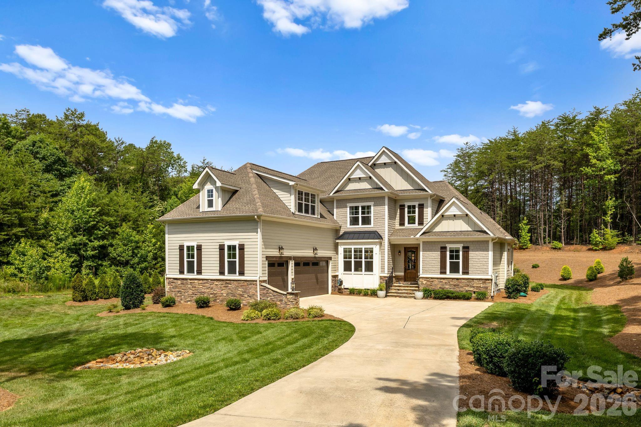 Welcome to 3207 James Plantation Drive, an extraordinary modern farmhouse-inspired residence located within the exclusive gated community of James Plantation in Denver, North Carolina. Designed with impeccable craftsmanship and timeless elegance, this exceptional home offers luxury living with thoughtfully designed spaces that perfectly blend comfort and sophistication. Meticulously maintained and in like-new condition, this home offers the quality and feel of new construction without the wait. From the moment you arrive, you'll be captivated by the home's stunning curb appeal, beautifully landscaped grounds, and an oversized three-car garage. Inside, the open floor plan is enhanced by soaring vaulted ceilings in the living room, dining area, and luxurious primary suite. Warm natural wood beams, tongue-and-groove ceiling accents, and a striking shiplap and stone fireplace create an inviting atmosphere that perfectly balances modern sophistication with farmhouse charm. The main level is thoughtfully designed for effortless everyday living and entertaining, featuring the primary suite, a private home office, elegant formal dining room, spacious laundry room, convenient wet bar, and an impressive great room that flows seamlessly into the gourmet kitchen. The private office, located adjacent to a full bathroom, offers exceptional flexibility and can easily be converted into a main-level guest bedroom—perfect for multi-generational living, overnight guests, or those seeking additional first-floor accommodations. The primary suite is a true showpiece and private retreat. The vaulted ceiling creates an airy, luxurious feel, while the spa-inspired ensuite bath offers a custom marble walk-in shower, a freestanding soaking tub, dual vanities, and premium designer finishes. Every detail has been carefully curated to create a space that rivals a luxury resort. With the primary suite, office (or potential guest bedroom), full bath, laundry room, bar, dining room, and main living areas all located on the first floor, the home's layout offers exceptional versatility while additional bedrooms and flexible living space upstairs provide privacy for family and guests. Step outside to discover a private backyard designed for both relaxation and enjoyment. Whether hosting friends, gathering with family, or enjoying a quiet evening on the outdoor living spaces, you'll appreciate the peaceful setting and the established blackberry bushes, which provide fresh, homegrown berries throughout the season and add to the property's natural charm and beauty. James Plantation is one of the Lake Norman area's most sought-after gated communities, offering tree-lined streets, custom luxury homes, and a tranquil setting just minutes from Lake Norman, golf, shopping, dining, and an easy commute to Charlotte. 3207 James Plantation Drive is more than a home—it's a lifestyle. With like-new condition, exceptional craftsmanship, luxurious finishes, and a thoughtfully designed floor plan in one of Denver's premier gated communities, this is a rare opportunity to own an extraordinary luxury home without the time, expense, or uncertainty of building new.