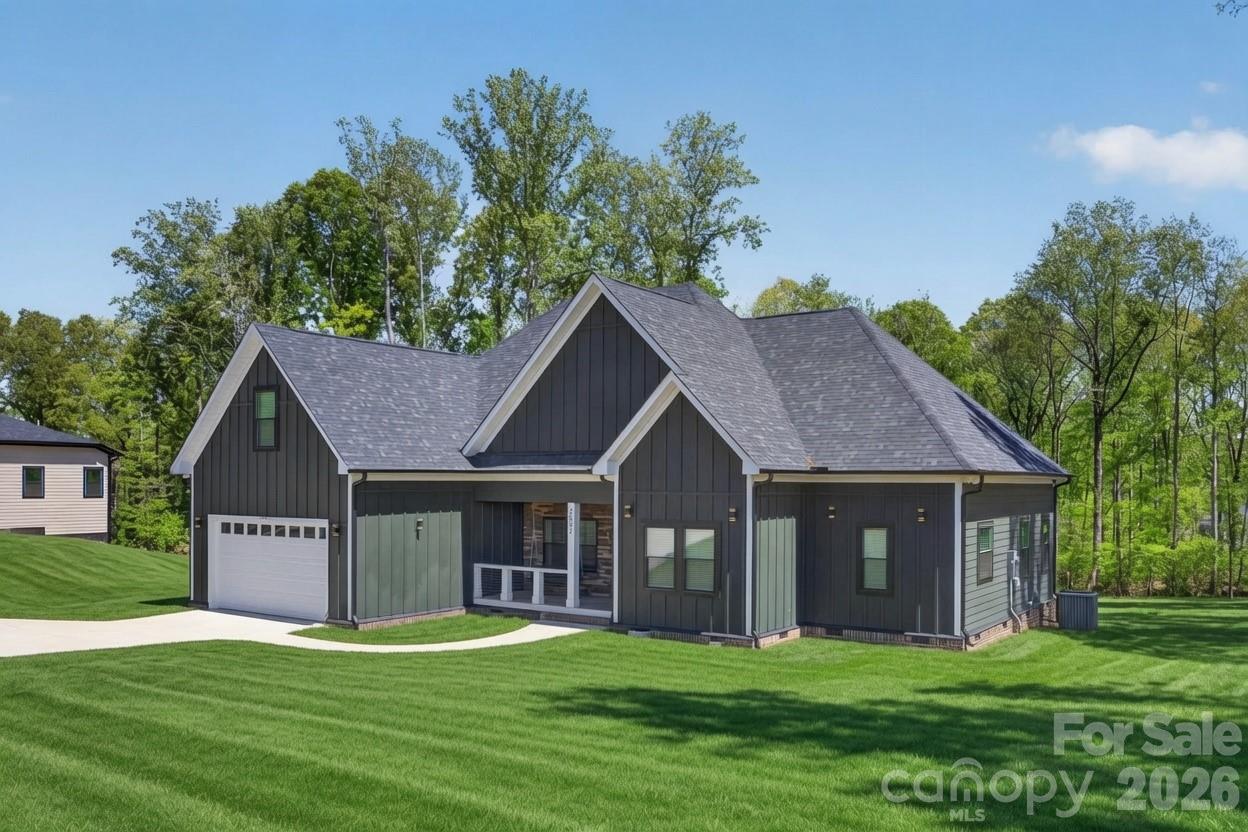 Charming 4-Bedroom Country Retreat on 1 Acre. Escape to your own peaceful oasis on a rare, expansive 1-acre lot in a serene, quiet neighborhood in Bessemer City – the perfect blend of privacy and convenience! Step onto the inviting covered front porch featuring elegant tile flooring, a stunning tongue-and-groove shiplap ceiling, stone veneer accents, and sleek cabled handrails – setting the tone for the exceptional craftsmanship inside. This move-in-ready single-family home boasts an open, airy floor plan with soaring ceiling heights in the foyer and great room that create a bright, spacious feel. Enjoy modern luxury with luxury vinyl plank (LVP) flooring throughout, a striking accent wall, cozy electric fireplace, and contemporary LED pendant lighting. The heart of the home shines in the gourmet kitchen, complete with stainless steel appliances, an undermount sink, crisp white shaker cabinets (including illuminated glass uppers for display), and sleek quartz countertops – ideal for everyday meals or entertaining. Upstairs, a large bonus room above the garage offers endless possibilities: a quiet home office, fun playroom, or personal theater retreat. With 4 generous bedrooms and 3 full baths, this home delivers comfort, style, and room to grow – all on a tranquil, private lot that feels worlds away yet close to everything Charlotte offers. Don't miss this rare opportunity – schedule your private tour today!
