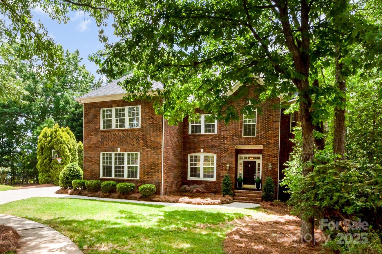 MOVE-IN READY LUXURY HOME in the heart of Tega Cay. The updated kitchen features white cabinets, stainless steel appliances (2023), granite countertops, modern backsplash and large island. The spacious breakfast area and ample storage make this kitchen a chef's dream. The 2-story great room is the perfect place to relax, with a vaulted ceiling, gas fireplace and beautiful wooded view. Entertain guests in the dining and living rooms, or retreat to the office for a peaceful workspace. Upstairs you'll find a beautiful primary suite with NEW spa-like bathroom: soaker tub, oversized shower, quartz counters, dual sinks and walk-in closet. Three additional bedrooms two updated full bathrooms and a huge loft area perfect for game nights are upstairs. Outside enjoy outdoor living at its finest with expansive decks and large hardscape fire pit on a quiet cul de sac. Storage solutions everywhere, including a 3-car garage with epoxy flooring. Check out this stunning project-free and updated home!