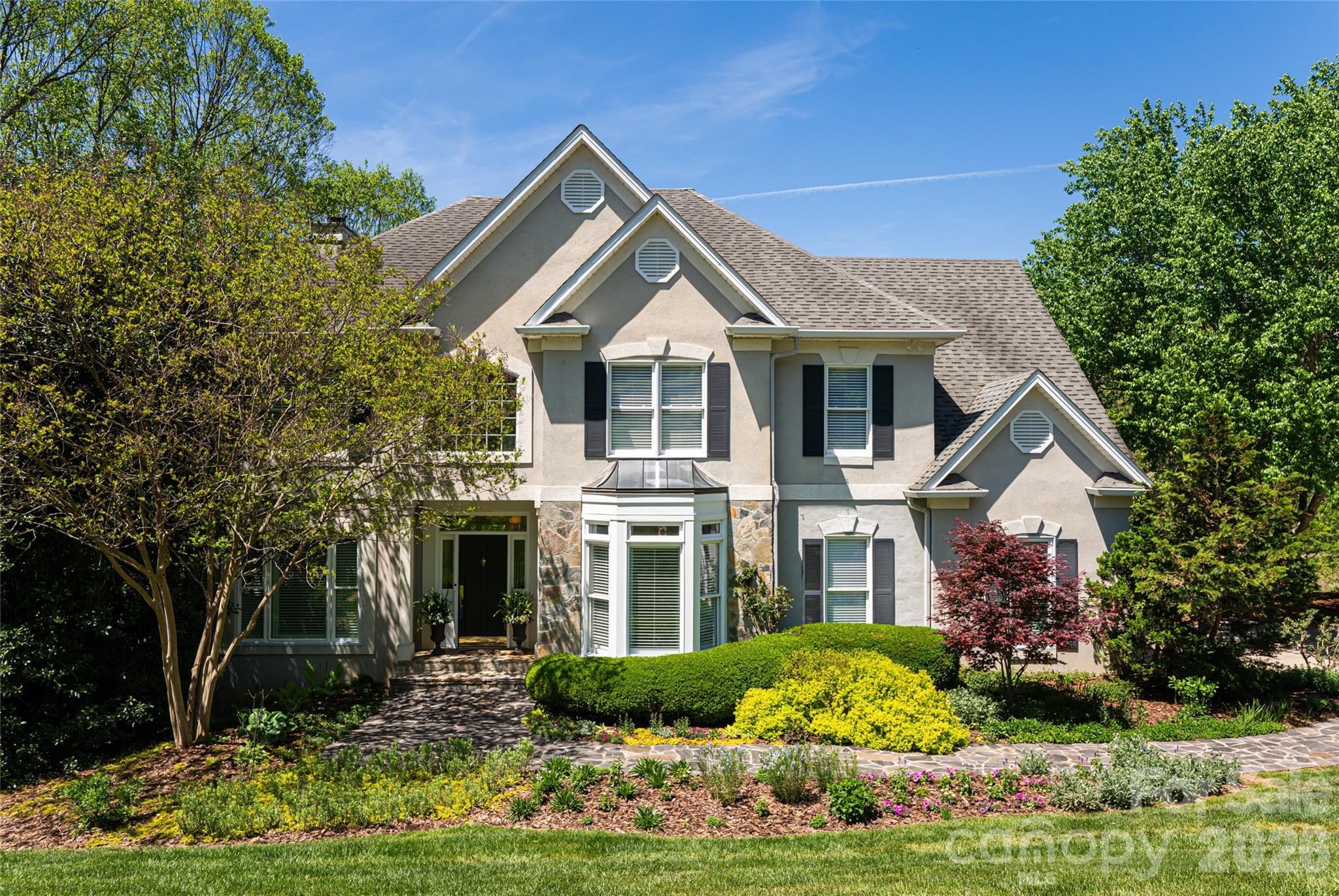A residence of rare scale and sophistication, this home blends modern luxury with timeless comfort because it has been thoughtfully updated and impeccably maintained.  On the main floor, the fully renovated chef’s kitchen commands attention with premium appliances and refined finishes. Seamless indoor-outdoor living unfolds onto a covered porch and open deck overlooking a large, private yard. The upper level features a generous primary suite with a spa-quality bath enhanced by heated floors and serene vistas. Additional bedrooms share the same level for convenience and flow and have renovated bathrooms and large closets plus the laundry room is on the second level added ease. The expansive lower level suite adds versatility by offering the perfect setting for guests, a private studio, or a recreation space. Close to the Beaver Lake walking trail and bird sanctuary, restaurants, and shopping but with a world away feel.