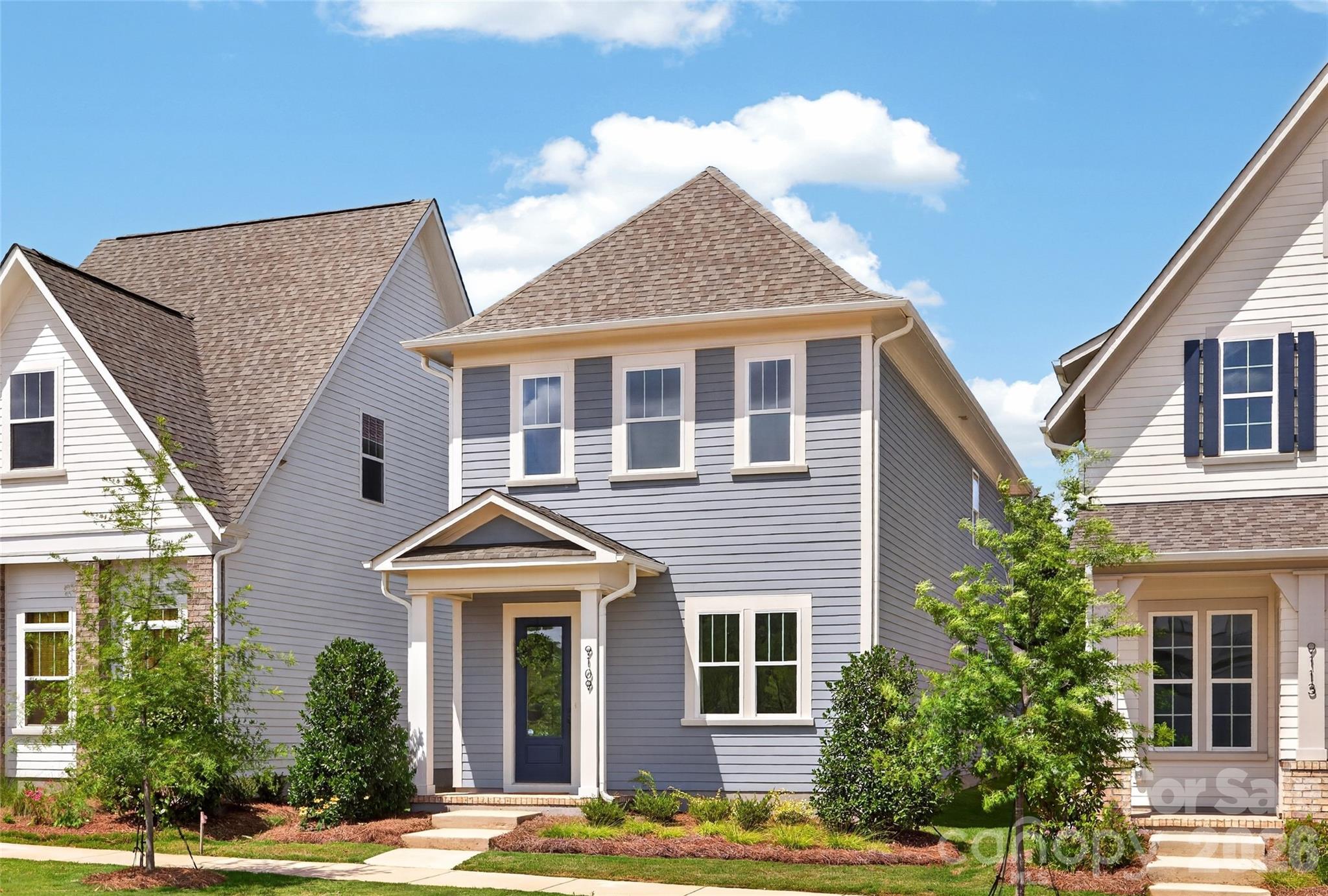 NEW CONSTRUCTION in East Charlotte - This home features an open design with 10' ceilings & 8' doors/cased openings on first floor, spacious kitchen w/quartz counter tops, under cabinet lighting & center island w/single bowl sink & walk-in pantry. Electric fireplace in family room w/vertical shiplap backer. Luxury vinyl plank flooring on main level & upper hallway. Drop Zone at rear hallway. Iron picket stair railing w/oak treads. Primary bedroom on upper level w/ LVP flooring, full bath, double vanity, oversized tiled shower & walk-in closet with 2nd doorway to laundry room at hallway. Laundry cabinets above w/d location & opposite side providing a convenient folding area. 9' ceilings on upper level w/2 guest bedrooms with walk-in closets. Hall bath with tub/shower combo & ceramic tile walls & flooring. Covered rear porch for relaxing evenings. 2-car detached garage w/alley access. Ring doorbell & camera w/Yale front door lock. Front lawn maintenance & irrigation covered by HOA.