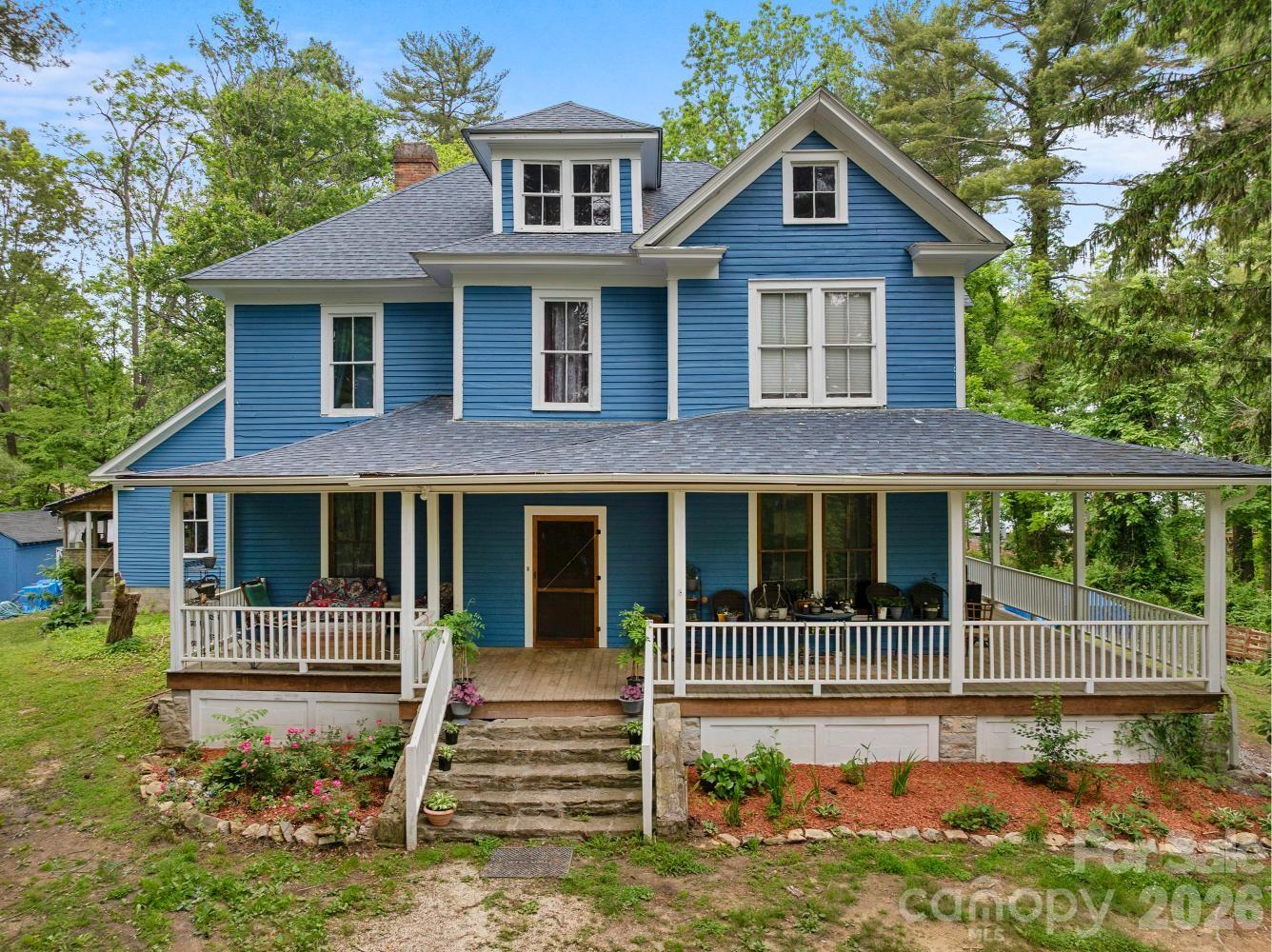 $60,000 PRICE REDUCTION – now under tax value – and a potential seller-paid credit at closing of up to $15K for buyers to use toward their due diligence inspection costs (conditions apply). Original farmhouse (c.1905) on 3.23 acres close to Hendersonville Country Club offers a variety of living and investment possibilities. This expansive home with unfinished caretaker’s cottage accommodates multi-generational/extended family living and gathering uses, rental income, and acreage development potential. Interiors primarily restored by the current owners with aim to preserve original features, including floors and staircase. The main level’s central foyer, featuring the original (restored) wood stove, is flanked by 3 bedrooms/sitting rooms, a spacious living room, and an expansive eat-in kitchen with double appliances, walk-in pantry, cabinets aplenty and a large “butcher-block”-style island. The main level also offers a bonus/flex room, 1.5 baths, laundry, and an unheated and unfinished storage room (future greenhouse?). Venture up the staircase to the second level and you’ll find another central foyer serving 3 bedrooms, a full bath with standalone spa, a half bath and another laundry. A third (attic) level is unfinished and unheated, but with a full bath already installed. Home’s exterior is original clapboard, painted in 2025. Roof replaced in 2019. Original windowpanes replaced. Heating/AC provided by mini-splits, wall units, wood stove and 10 fireplaces. Two cellars, separate workshed. Home is served by city water, natural gas, high-speed internet. It’s all on level to gently sloped acreage in a charming, evolving neighborhood, making NOW the best time to buy.