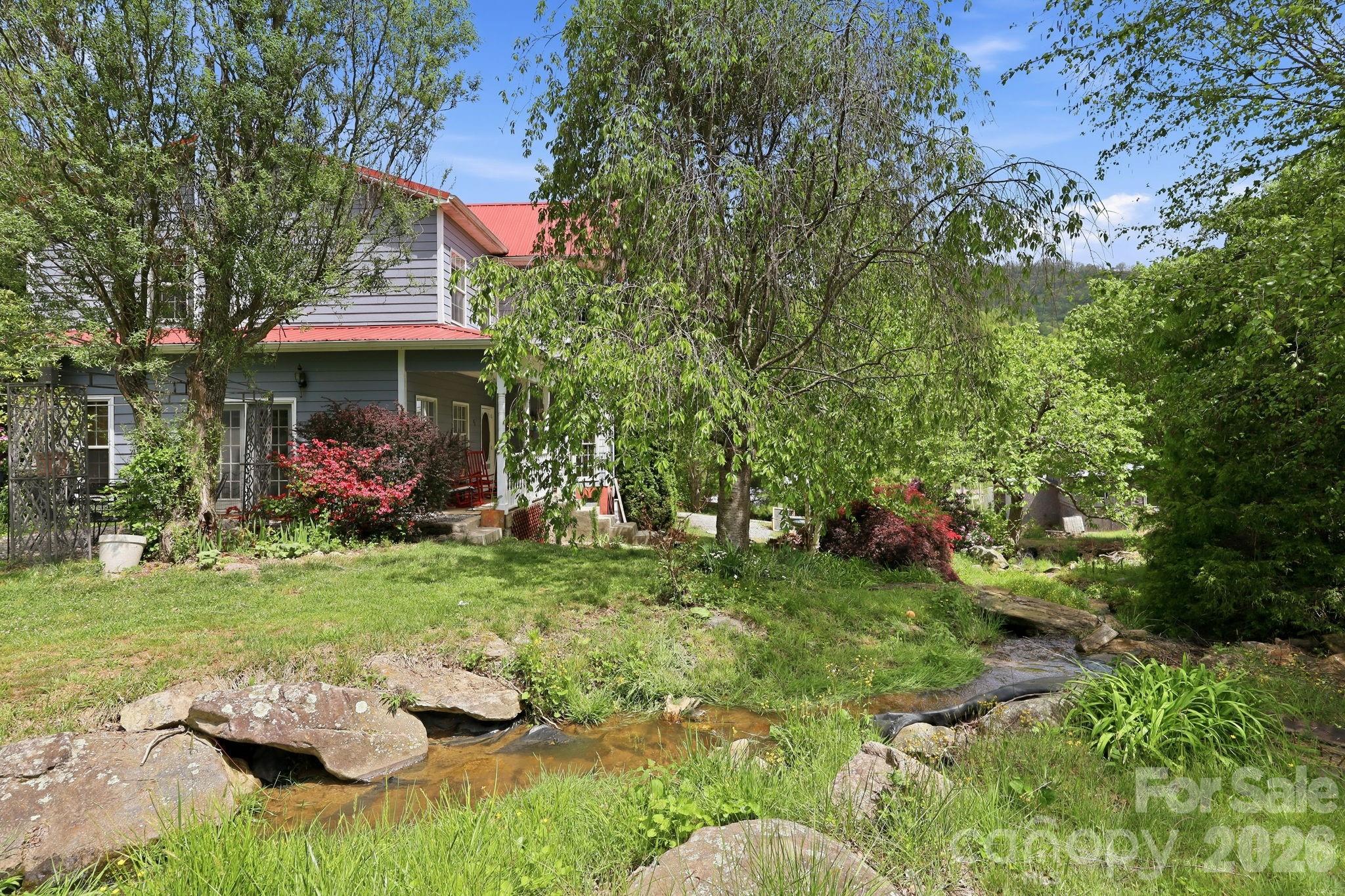 Country living at its finest! This unique 4-bedroom, 2-bath home offers peace, privacy, and access to something truly special — over 491 acres of communal HOA acreage for homeowners to enjoy at their leisure, with no future development or additional homes to ever be built on it.

Wake up to the peaceful sound of a babbling brook and small waterfalls just outside your windows, creating a tranquil setting that is hard to find. The property is surrounded by mature trees and natural beauty, making it a dream for outdoor enthusiasts, hunters, hikers, and anyone looking to escape the hustle and bustle of city life. Enjoy access to a stocked pond for fishing, miles of space to explore, and nature right outside your door.

Inside, the home offers comfortable living with a breakfast nook, formal dining area, and the convenience of an upstairs laundry room. The spacious primary suite features an adjoining sitting room or office, providing the perfect space to work from home or relax in private. Radiant heated floors add a touch of luxury and year-round comfort throughout the home.

Outside, you'll find plenty of room for gardening and homesteading, along with a large 30' x 30' detached garage/workshop offering endless possibilities. Previously equipped with water and septic connections, the workshop may offer future opportunities for conversion back to a functional workspace, studio, or additional use.

If you've been searching for privacy, usable land, breathtaking natural surroundings, and true country charm, this is an opportunity you won't want to miss.