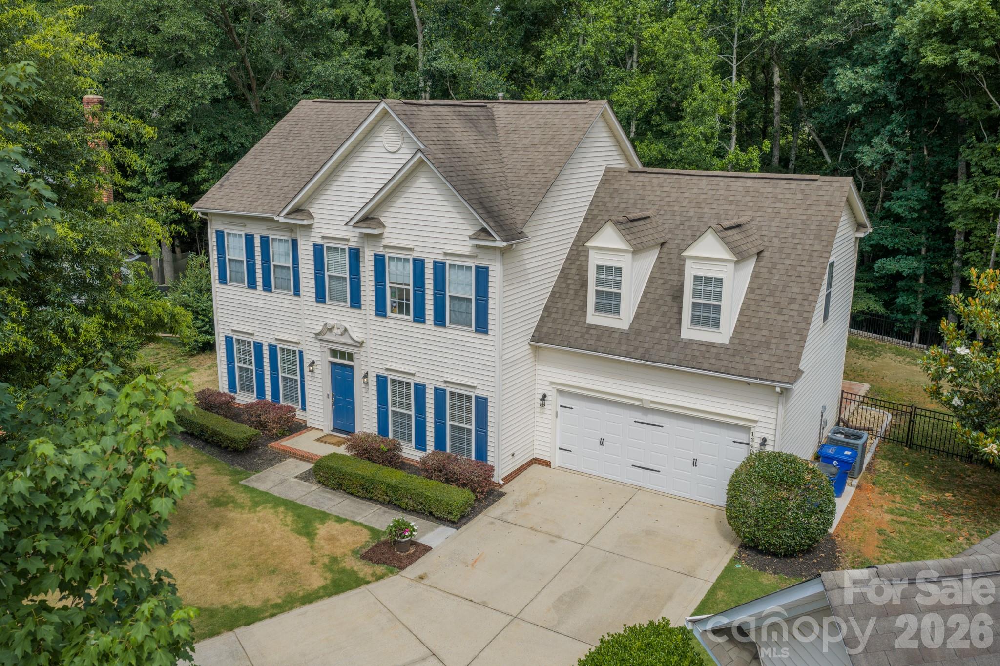 Beautiful 4 bedroom, 2.5 bath home with a dedicated office and sunroom, perfectly situated on a flat 0.26-acre cul-de-sac lot in desirable Cardinal Woods. Enjoy a private, fenced backyard with peaceful wooded views of community green space.  The inviting main level features 9-foot ceilings, durable luxury vinyl plank flooring, and an open layout.  The spacious family room flows into the breakfast area and kitchen, complete with stainless steel appliances and island.  Upstairs, the elegant primary suite offers tray ceilings, a generous walk-in closet with a custom organizer, 2 additional bedrooms as well as a bonus/4th bedroom and a convenient second floor laundry. The heated and cooled sunroom, serviced by its own mini-split system and included in the home's heated living area, provides the perfect space to relax, work, or entertain year round.  Thoughtful 2026 updates include an upgraded CPI security system, retaining wall with aluminum fencing, new garage door, epoxy garage flooring, blackout shades in three bedrooms, and Ethernet connections in both the office and bonus/4th bedroom.  Ideally located just minutes from I-485, I-77, Four Mile Creek Greenway, and the Ballantyne Bowl, this home combines modern updates, functional living spaces, and a convenient location. Welcome Home!