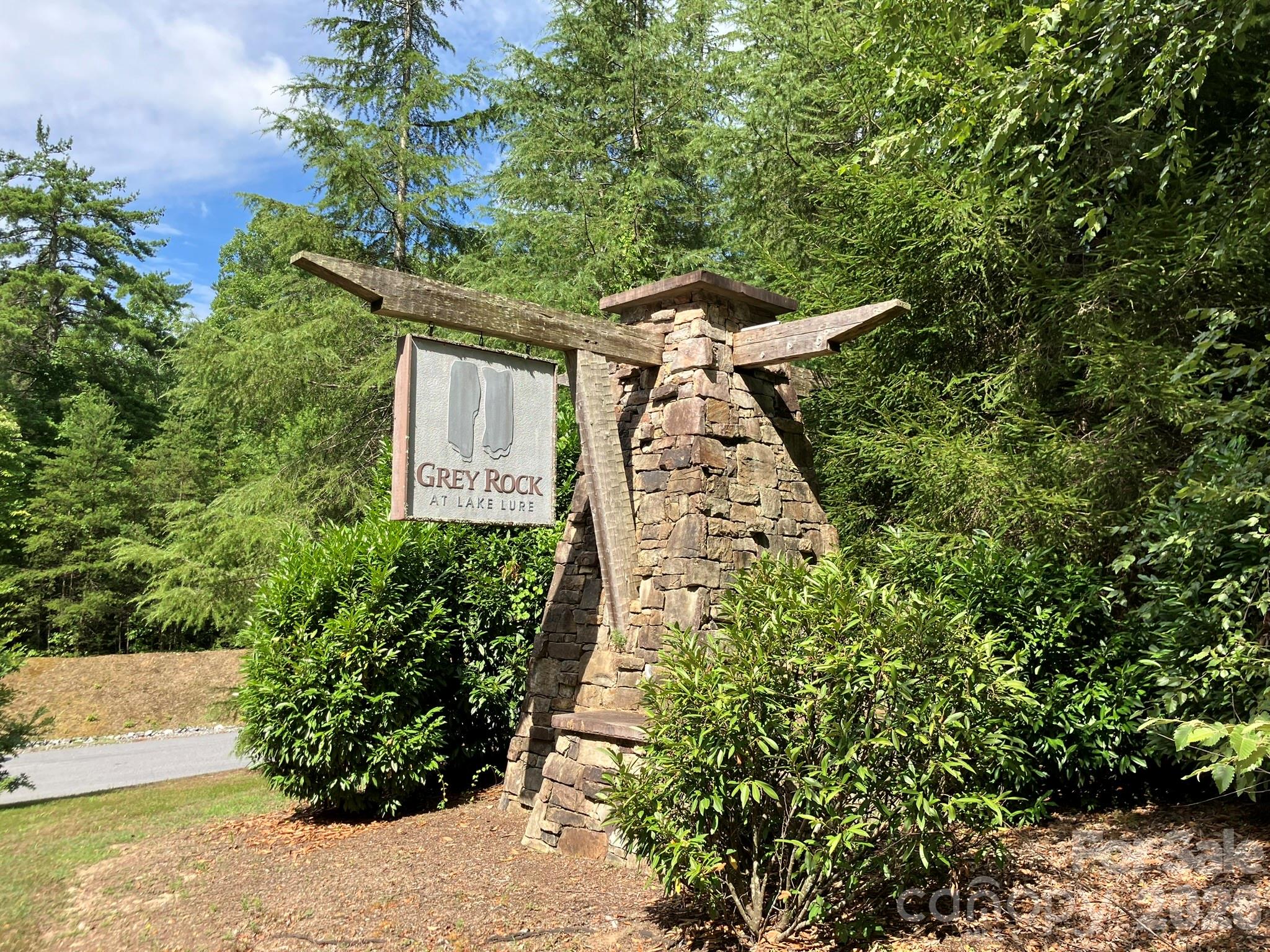 Build your mountain getaway in Grey Rock at Lake Lure. Lot 225 offers a private, wooded setting within a gated community nestled in the foothills of the Blue Ridge Mountains, known for its natural beauty and peaceful surroundings.

The $15,000 electric assessment is to be paid by the buyer at closing, contributing toward utility infrastructure within the community. The lot is ready for your vision (well and septic required). Grey Rock maintains paved roads throughout the community and a minimum 1,800 square foot build requirement, supporting quality construction and accessibility. Whether you're planning a full-time home or a second residence, this property provides flexibility in a desirable location.

Grey Rock is known for its quiet atmosphere, abundant wildlife, and well-maintained surroundings—ideal for those seeking a full-time residence or a mountain retreat. Residents enjoy convenient access to the Lake Lure area, including boating, fishing, kayaking, and the public beach.

Nearby Chimney Rock State Park offers hiking trails, rock climbing, and long-range views of Hickory Nut Gorge. Additional area attractions include golf courses, equestrian facilities, and outdoor recreation throughout the region.

If you’ve been waiting for the right combination of location, setting, and value—this homesite is worth a closer look.

Additional community information available at www.greyrocktoday.com