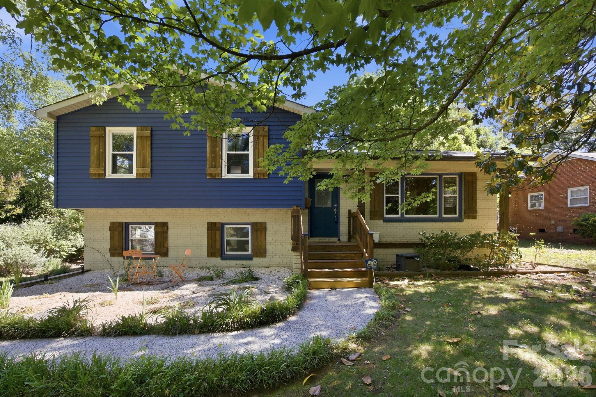 Mid-century bones, serious infrastructure, and a property designed for cooks, hosts, green thumbs and creators. 

The main residence is a four-bedroom, two-bath tri-level with two generous living areas and natural light contrasting rich hardwoods. The kitchen has been fully rebuilt, quartz counters, new cabinetry, new bosch induction cooktop, convection oven and refrigerator; a  kitchen for people who love to cook and entertain. 

The climate-controlled workshop and studio with lofted storage above the garage is scaled for serious maker or creative studio operations; and wired for what comes next. ADU potential subject to buyer verification of zoning and permitting.

Outside is an intentionally designed garden filled with color, with flagstone paths through japanese maples, corten steel planters, a curated perennial garden in bloom February through November, fruiting peach and pear trees, deck, fire pit, hot tub. 

A relaxing oasis with remarkable features so close to NoDa, Plaza Midwood, and Uptown. Substantial capital improvements completed; full list in agent remarks.