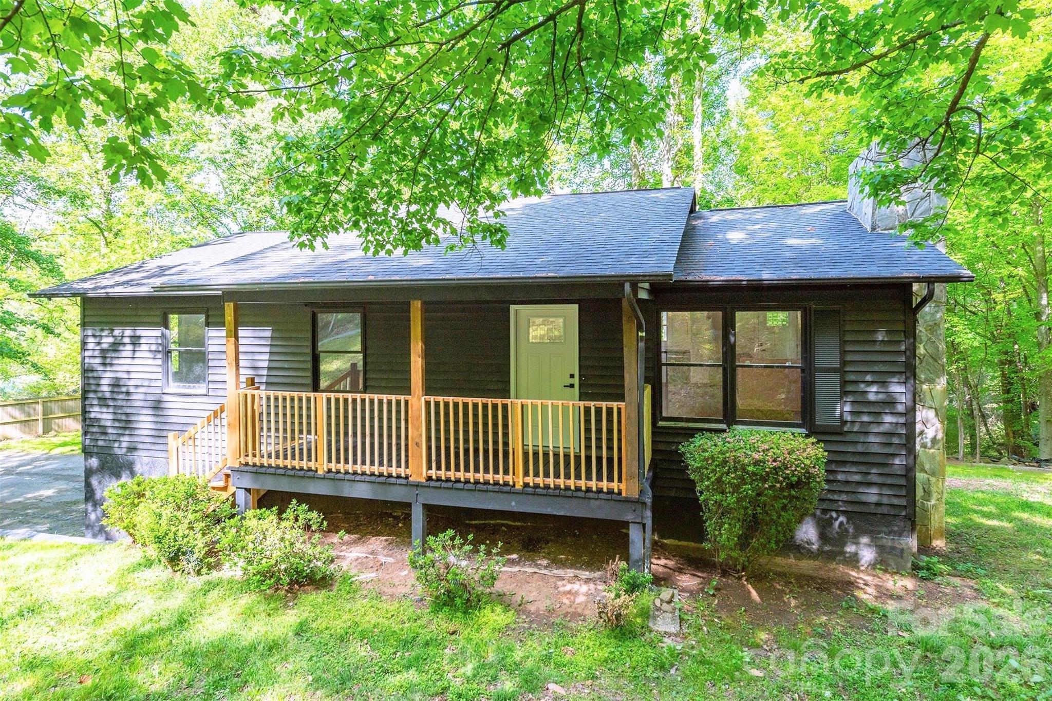 Tucked away on a private 0.68-acre lot, this fully updated home blends comfort, space, and everyday convenience. Offering 3 bedrooms, 3 bathrooms, and nearly 2,000 square feet, the layout feels both functional and welcoming.

The main level showcases an open kitchen and living area with vaulted ceilings, filling the space with natural light and an airy, expansive feel. The kitchen has been fully renovated with new cabinetry, and all bathrooms along with the flooring throughout the home have been updated for a fresh, modern finish.

Downstairs, the finished basement provides added flexibility with a second living room or TV space, a dedicated office, and extra storage. A one-car garage plus additional storage areas give you plenty of room for tools, recreational gear, or hobbies.

Outside, a brand-new back deck stretches the full length of the home and overlooks a peaceful wooded backdrop. The yard combines usable grassy areas with natural surroundings, and even includes an existing play set.

Set in a quiet Swannanoa community with city water and sewer, the home offers convenient access to both Asheville and Black Mountain while still maintaining a secluded, tucked-away feel.