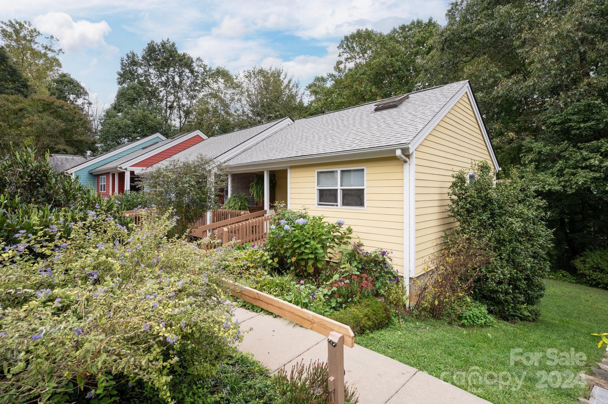 Welcome to Westwood Co-housing in the heart of West Asheville!  Walkable to Haywood Road amenities, this multi-generational eco-conscious co-housing community includes community solar panels that support heating & hot water for all units, wooded area w/ creek & walking trails, fire circle, common house, playground, & sustainable structures.  The parking area includes a bike shed, covered spaces, & electric car charging stations. The common house includes a well appointed kitchen for preparing shared meals, meeting/dining space for socials, library, workshop, co-working space, additional laundry & guest rooms. The terraced community gardens include irrigation from community rain water catchment system. Unit A4 is an end unit w/ 3BD/2BA.  Enjoy the open floor plan, natural light, screened lower patio, upper deck and covered front porch.  Enjoy the beautiful gardens in the multiple settings this unit provides. Make sure to ask about all the features and benefits covered through the HOA.