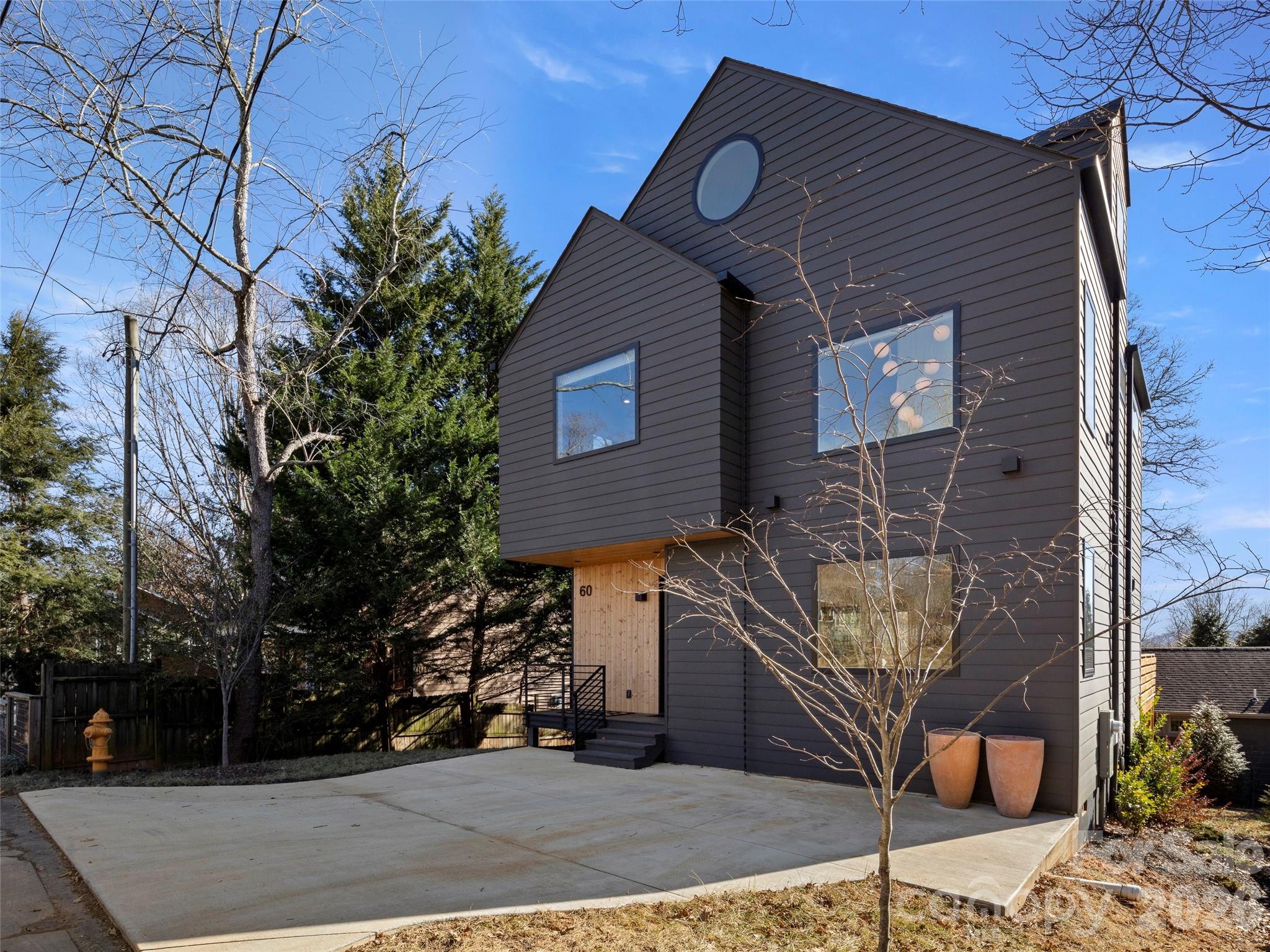 Welcome to 60 Harvard Place, a striking modern home in West Asheville's desirable Horney Heights. Built in 2022
by Mystic Builders, this three-level home features an open floor plan with vaulted ceilings and oversized Anderson windows that flood the space with natural light. The sleek Euro-style kitchen boasts custom cabinetry and quartz countertops. Upstairs includes a private primary suite, two additional bedrooms, and a stylish laundry room.  Bathrooms feature custom tile, stone countertops, and a soaking tub. A top-level bonus room offers flexible space for work or play. Enjoy outdoor living on the 400 sq ft partially covered back deck. Energy-efficient construction adds comfort and value. Just minutes from Malvern Hills Park and West Asheville's shops and dining, this home blends modern design with an unbeatable location. Come live the mountain life in this amazing home. Average monthly utility bills are extreamly low, Electricity $66.96, Gas $28.56, Water and Sewer $47.94. This is for the past 12 months through March of 2026. Buyers costs may be differnt due to lifestyle.