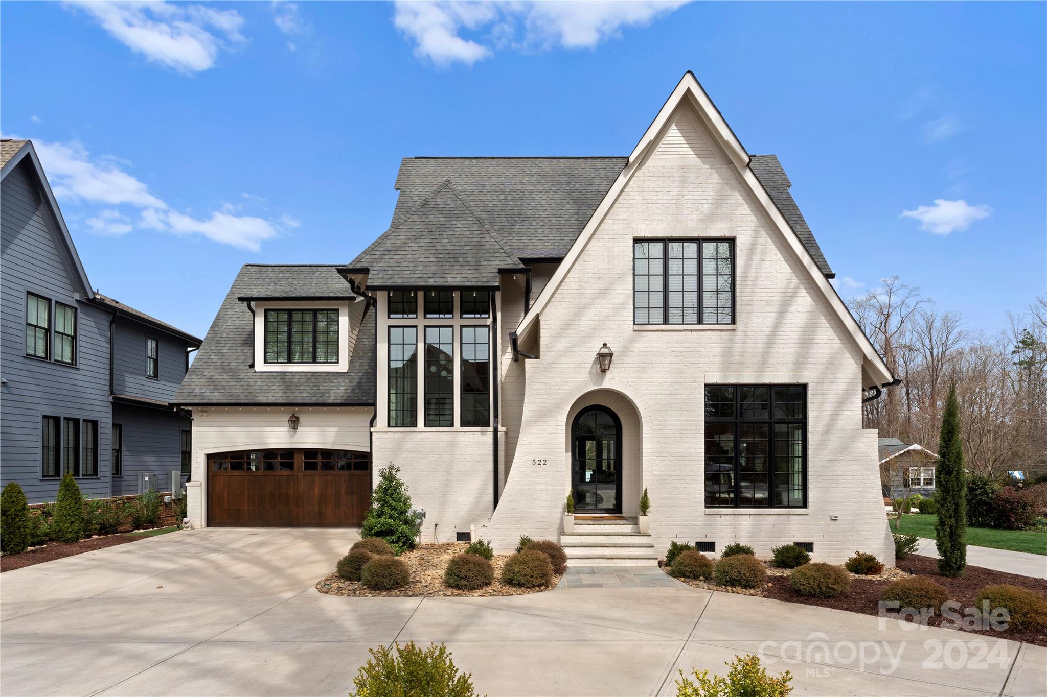 This impressive 5-bed, 4-bath home located in Cotswold is meticulously detailed. It features an open layout, 10' ceilings, and ample natural light for a bright, inviting atmosphere. The main level hosts a fully equipped guest suite, while the upper level accommodates 4 bedrooms and a bonus room. The expansive kitchen, a focal point, boasts Sub Zero appliances, a 48" Wolf Range, Asko dishwasher, custom Quartzite countertops, and a spacious walk-in pantry with a coffee bar. Designed for entertainment, the home includes an in-ceiling Sonos surround sound system in the family room and on the covered Trex deck. Outdoor amenities feature a heated saltwater plunge pool, wood fireplace, golf practice swing cage, and turfed yard. Custom features like wooden garage doors and a reverse osmosis water system add to the overall allure. Thoughtful landscaping, including fast-growing trees in the backyard will ensure privacy, complemented by front and back landscape lighting.