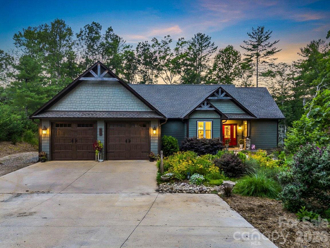 Welcome home to your Waterfront 3-bedroom, 3 bath retreat on Lake Adger. This lovely home is nestled on 2.68 acres in the peaceful Southcove section of Lake Adger.  Designed for both everyday living and entertaining, this wonderful home features an open floor plan highlighted by dramatic cathedral ceilings, beautiful wood beams and a stunning stone fireplace in the great room. The kitchen and dining area offers a large island, abundant cabinetry, pantry, and plenty of room for gathering with family and friends. The main level includes a well-appointed primary suite and office, as well as a second bedroom and bath, providing comfort and convenience for owners and guests alike.  The lower level features a generously sized bedroom, full bath, and a large recreation room complete with a wet bar—perfect for a game room, or family room.  It also includes a hidden room behind a bookcase plus, a work shop that could easily be used as UTV storage, and an unfinished area for additional storage or future expansion. 
Lake Adger is a private, gated community centered around a pristine 438-acre lake with 14 miles of shoreline. Residents enjoy boating, fishing, kayaking, and an extensive network of scenic walking and equestrian trails that wind through rolling hills, mountain vistas, tranquil streams, and preserved natural beauty. This is mountain-lake living at its finest.