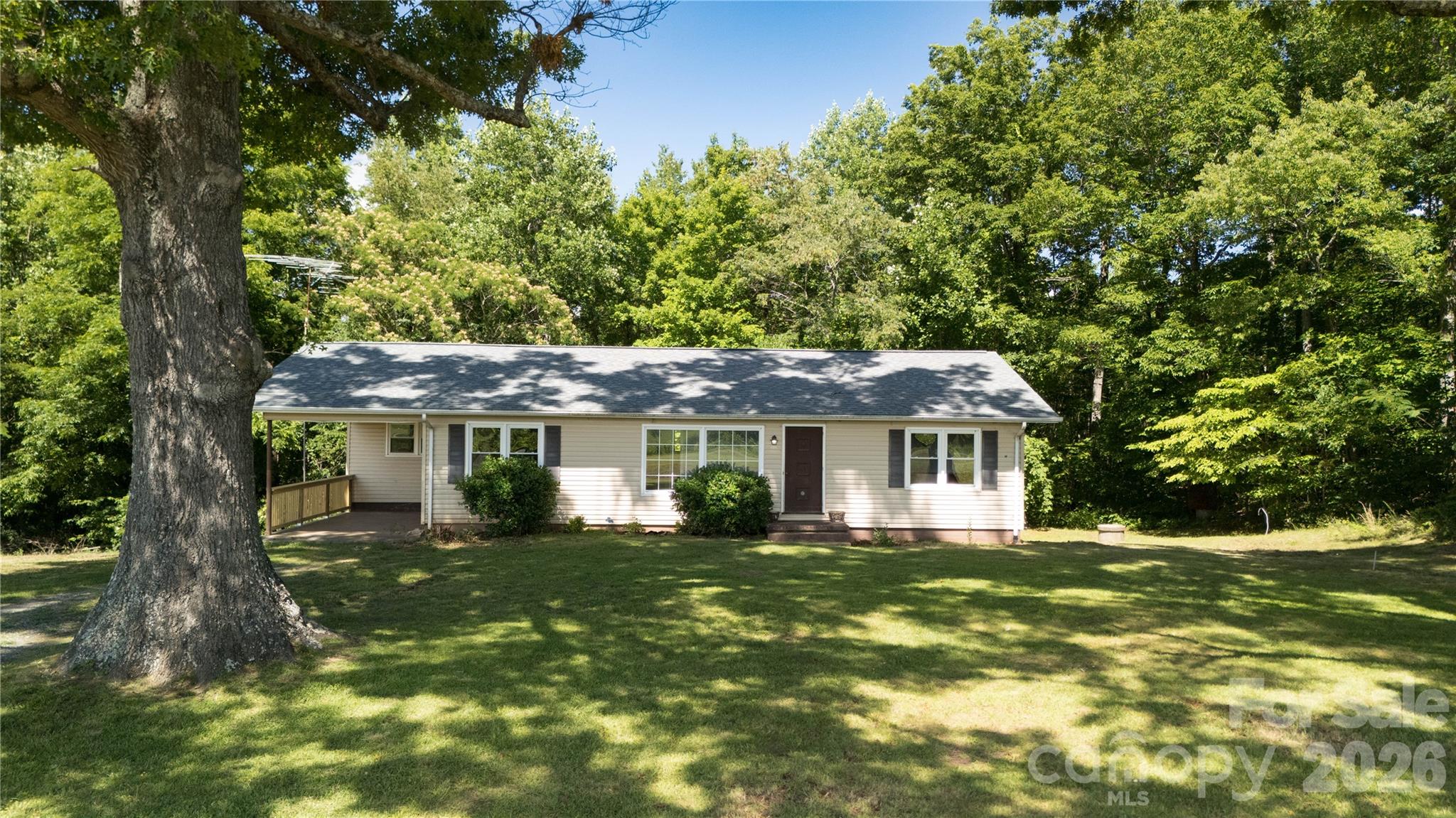 Some places simply feel different.

At 540 Crutchfield Road, the landscape has been shaping memories long before the home was ever built. Massive hardwood trees, now more than a century old, frame the property with their sprawling branches and welcome shade. Beyond them, open pastures roll toward the horizon where the Blue Ridge Mountains rise in the distance, creating a view that never seems to get old.

From the living room, the mountains become part of everyday life. Morning coffee comes with a front-row seat to changing seasons, drifting clouds, and the quiet beauty that makes this part of North Carolina so special.

The home itself has been thoughtfully refreshed with new flooring and fresh paint throughout, creating a clean and inviting space ready for its next chapter. Offering three bedrooms, one full bath, and a convenient half bath, the single-level layout is comfortable, practical, and easy to enjoy. A full basement provides additional storage and workspace below.

Outside, a large wooden workshop stands ready for projects, equipment, hobbies, or simply a place to tinker. The yard offers plenty of room to spread out, garden, or relax beneath the shade of trees that have stood here for generations.

The property has also been recently surveyed, with boundary markers already in place, making it easy to understand exactly what you're purchasing.

This isn't a subdivision home with a mountain-themed name and a distant glimpse of a ridge. This is a genuine foothills property where the views are real, the trees are old, and life moves at just the right pace.