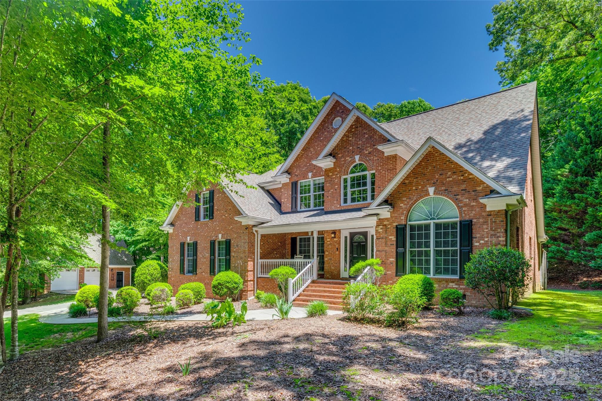 Welcome home to this custom full brick home in the heart of Fort Mill! This beautiful well-kept & maintained home is on approximately 1.66 acres(GIS says 1.71). The 2 story family room is filled w/ light w/ two story windows & features a gas fireplace. The kitchen & family room are perfect for hosting gatherings as they overlook private backyard.  This gorgeous home offers large primary suite on main level. The home office w/vaulted ceiling is right off the entry way and features French doors & the other side of entry is a formal dining room, large kitchen w/ granite counter tops & breakfast area. Separate wine/coffee bar. Upstairs features 3 large BRs, one w/ its own full bath & extra large bonus room. Low maintenance trex deck features hot tub & beautiful private view. Plentiful storage areas upstairs so you can live clutter-free. 2 car attached garage & separate 2 car garage/shop w/ storage upstairs. Top-ranked FM Schools, nearby access to Catawba River & close access to Charlotte.