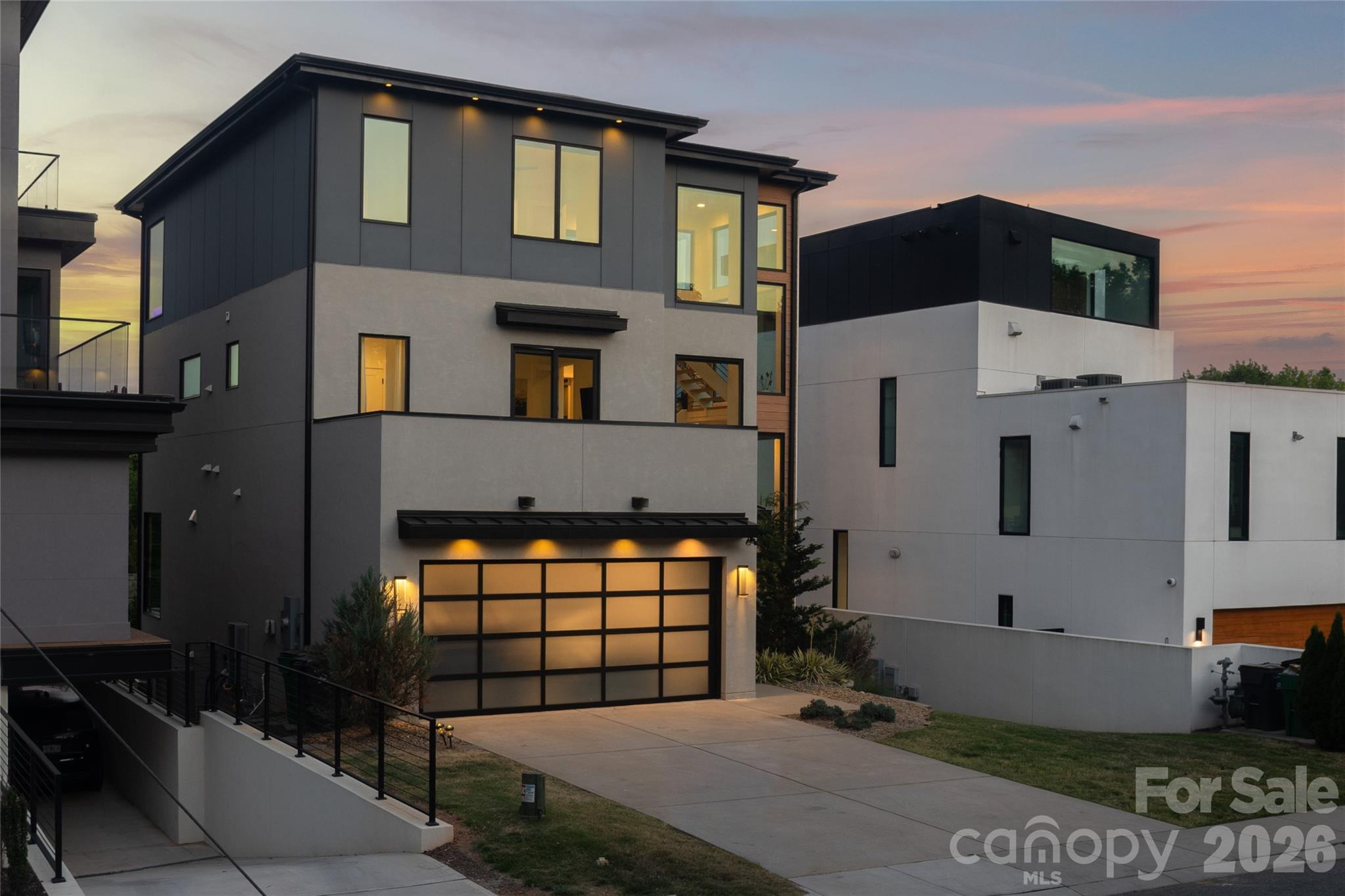 Perched above the city at 308 Fraizer Ave, this ultra-modern residence offers some of the most breathtaking, unobstructed skyline views available. With 4 bedrooms and 4.5 baths, this home offers  a striking blend of architectural precision, natural light, and elevated design.

A dramatic open-tread suspended staircase anchors the main living space, complementing expansive glass walls that flood the home with sunlight and frame the city beyond. 

The chef’s kitchen is both modern and functional, featuring a hidden scullery for seamless entertaining and clean sightlines. Builder spared no expense with this one: 60' freezer/fridge, waterfall counter tops, under cabinet lighting, and sleek push to open cabinets.

Designed for true indoor-outdoor living, the home boasts four expansive patios, a stunning rooftop bar and a lounge, creating an unparalleled setting for entertaining against panoramic skyline views.

The primary suite is a private retreat, complete with its own patio, motorized shades, dual custom closets, and a spa-inspired bath featuring separate vanities and dual shower heads.

The lower level is equally impressive, offering a dedicated media room, guest suite, hot tub, and a private putting course bringing resort-style amenities into your everyday living experience.

Offered fully furnished, this home is completely turnkey and ready to deliver a refined, modern lifestyle in one of Charlottes most coveted view corridors.