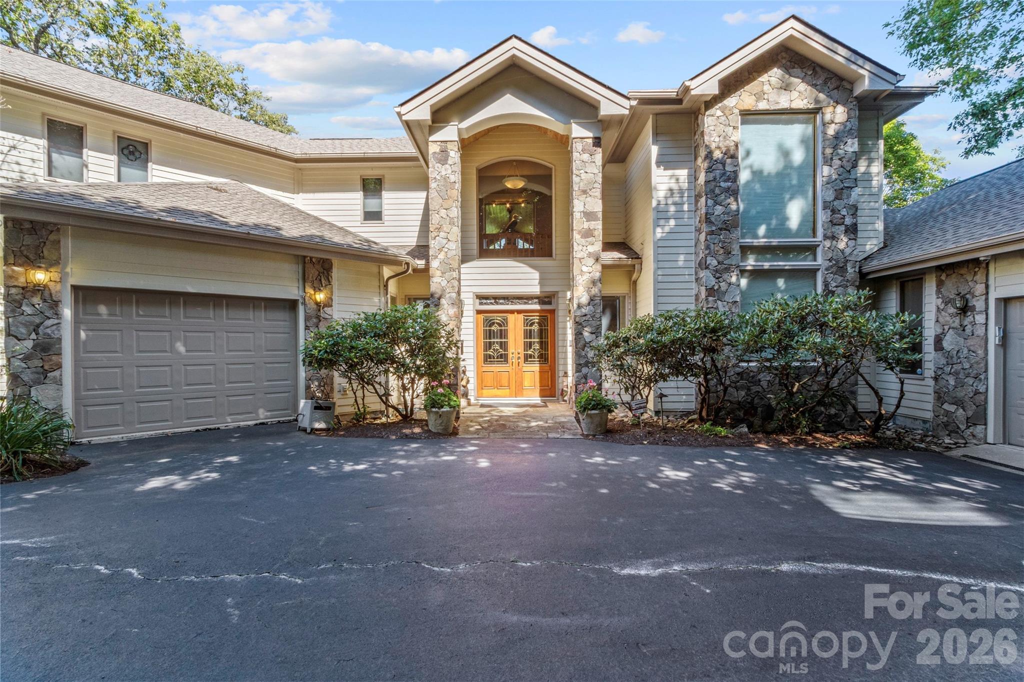 Privately situated at the end of Ball Camp Road in the prestigious MOUNTAIR AIR community, this stunning custom home offers more than 5,000 square feet of luxurious living space—perfect for hosting family and friends while enjoying complete serenity and privacy. The heart of the home is the spacious great room, featuring soaring two-story ceilings, floor-to-ceiling windows that flood the space with natural light, and a striking stone fireplace with custom built-ins. Gorgeous hardwood floors run throughout the home, enhancing its warmth and elegance. On the main level, you’ll find two generously sized guest suites, each with its own private bath, along with a convenient half bath for guests. The upper level is home to the primary suite, a true retreat with vaulted knotty pine ceilings and trim, a gas log fireplace, motorized blinds, and a luxurious en suite bath with a whirlpool tub. Also upstairs are a private office and an exercise room, both offering beautiful mountain views. Each of the home’s three levels features a gas log fireplace operated by remote control, adding comfort and charm. The lower level is designed for entertainment and relaxation, offering a large recreation room with a wet bar/mini kitchen, a playroom or game room, and an additional guest bedroom with full bath. This home is as functional as it is beautiful, with a Navien On-Demand water heater, a whole-house generator, and three separate HVAC systems—one for each floor—for optimal climate control. A two-car garage and a separate cart barn provide ample storage and house two golf carts. One golf cart will be included in the sale. The beautiful grand piano in the main living area is also included. The seller will consider including a full golf membership, valued at $95,000, with an acceptable offer. A full-price offer will automatically include this exclusive full golf membership, providing access to the world-class golf and amenities at Mountain Air.