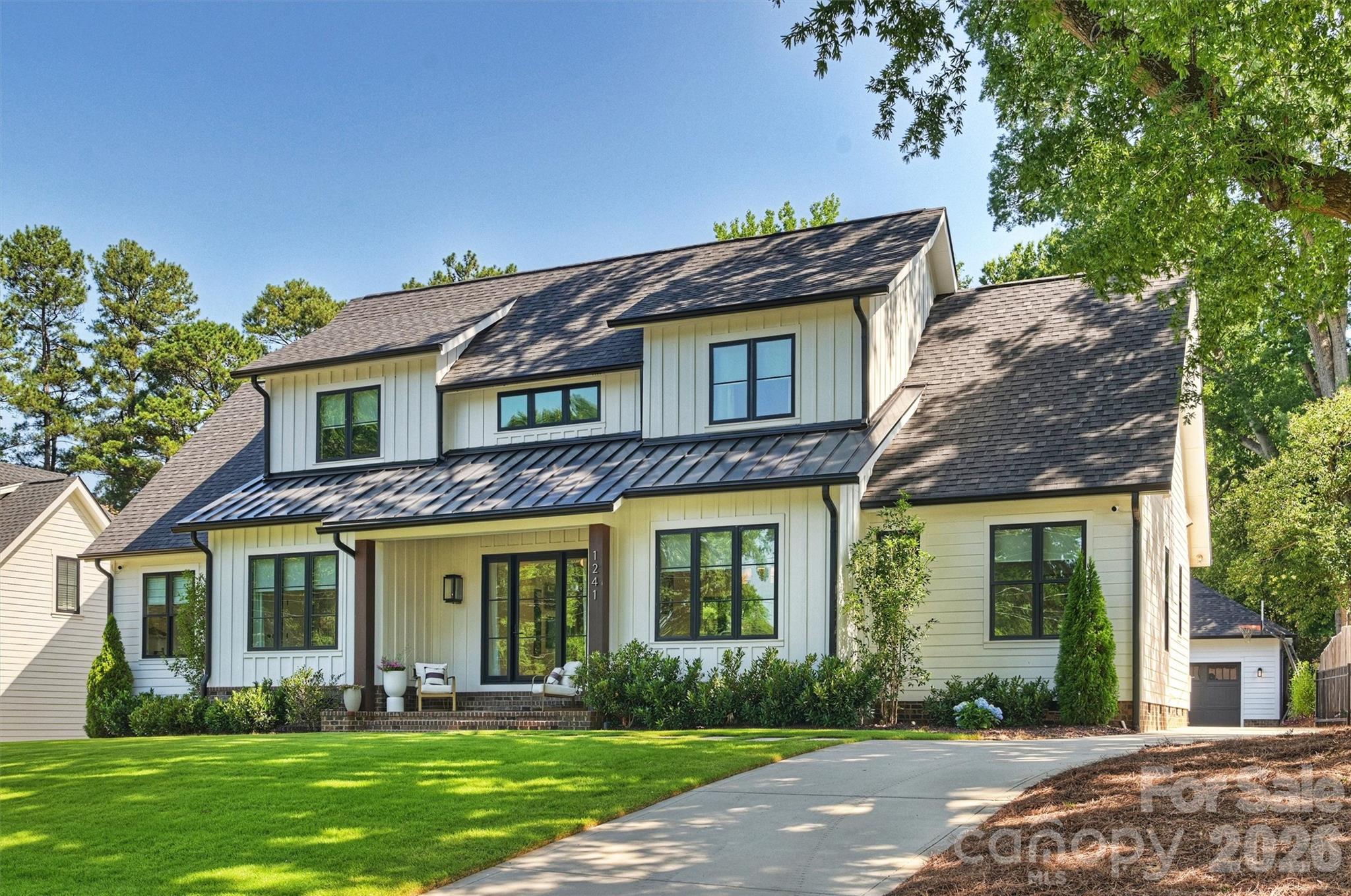 Modern luxury meets exceptional outdoor living in one of Charlotte’s most desirable neighborhoods. Situated on an extraordinary flat .39-acre lot, this stunning home offers the perfect combination of contemporary design, thoughtful functionality, and walkable convenience. The open concept floor plan features soaring ceilings, abundant natural light, and high-end finishes throughout. The designer kitchen is equipped with premium appliances, custom cabinetry, and sophisticated details that flow seamlessly into the main living and dining spaces which include a generous scullery. A dedicated office and two bedrooms on the main level provide exceptional flexibility for today’s lifestyle. Upstairs, you’ll find two additional bedrooms, a spacious bonus room, and versatile flex space and ample storage. Step outside to enjoy the massive screened porch overlooking the flat, private backyard with mature trees and new landscaping. Perfect for entertaining, relaxing, or future outdoor enhancements. See pool rendering for ideas. (A full quote is available.) The detached two-car garage and driveway are enclosed behind a gate. Located on one of Ashbrook’s most beautiful streets, just a short walk to Park Road Shopping Center, Montford’s renowned restaurants and bars. This is a rare opportunity to enjoy modern living on an oversized lot in a rapidly appreciating location. Sister community to Myers Park-top performing school district!