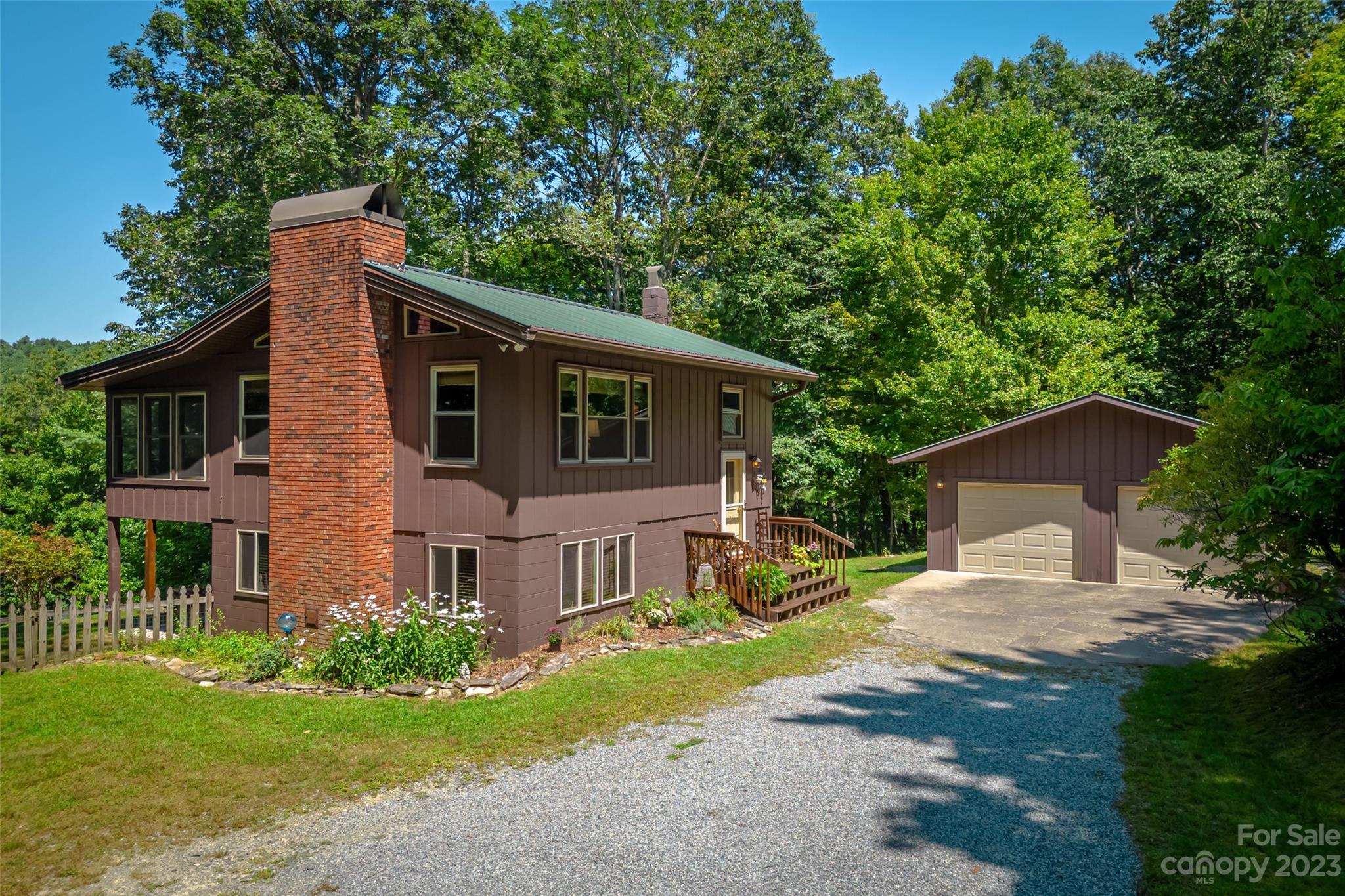 Bring your horses and enjoy this idyllic setting overlooking the Blue Ridge Mountains! At over 3000 ft elevation and year round lake access, the weather and scenery can't be beat! There is a charming one bedroom cabin (originally 2 bedrooms which were combined into one) on the ground floor with bathroom, coffee bar, and laundry facilities. The cabin is move in ready with furnishings included in the sale.  The property also has a spacious floored 2 car garage, shed and an open horse stable. The previous owner lived in the cabin year round and enjoyed the warmth provided by the free standing laser heater.
 The Slick Rock Community is quite unique and a great setting to live in year round or as a second home. The community lake is available to all who are part of the Association and provides opportunity for swimming, fishing, and canoeing. Planned activities for those who wish to participate include hiking groups, a book club and social gatherings.