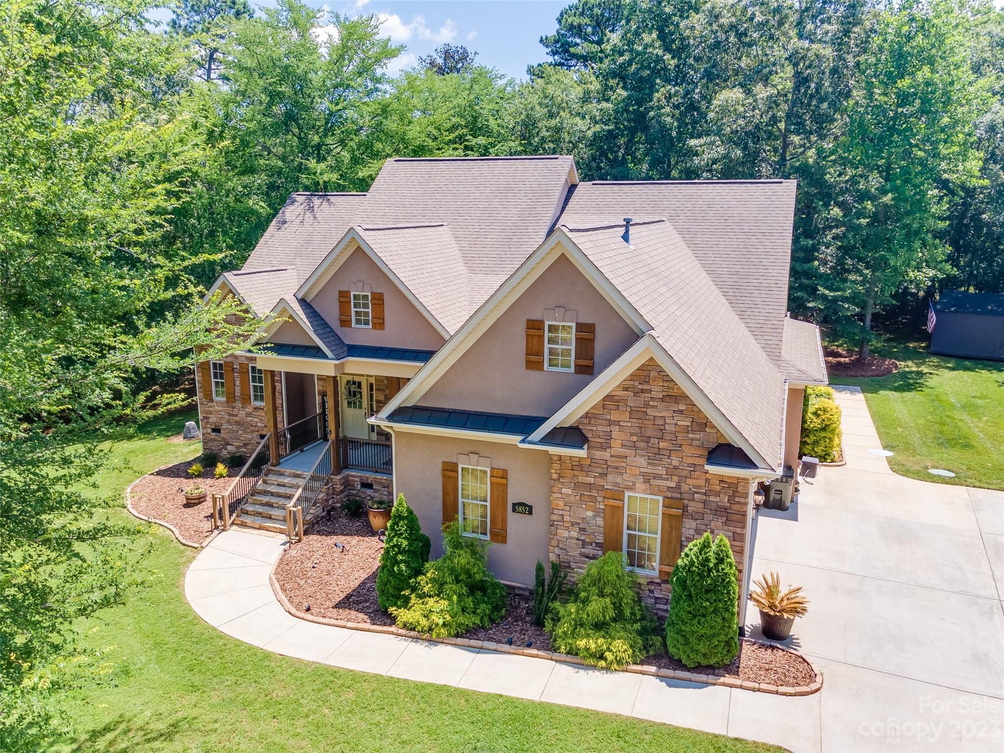 Welcome to your dream home! This stunning 1.5 story home is sure to impress. Situated on a sprawling lot that spans just over an acre, this property offers privacy, tranquility, and plenty of space to spread out and enjoy your surroundings. As you step inside, you'll be greeted by an open floor plan that's ideal for entertaining and relaxing with 2 gas fireplaces. The master bedroom is a true oasis with large windows overlooking the backyard, a spacious renovated en suite bathroom, large walk in closet, and access to the back deck. The two additional bedrooms on the main floor are equally spacious and share a full bathroom. Upstairs you'll find an additional bedroom, a full bath, and a large bonus room with separate kitchen area equipped with a mini fridge & microwave- perfect for popcorn! The large deck and patio offer plenty of space for grilling, entertaining, and enjoying the outdoors. Great location close to Lake Wylie, top rated schools, shopping, dining, & more!