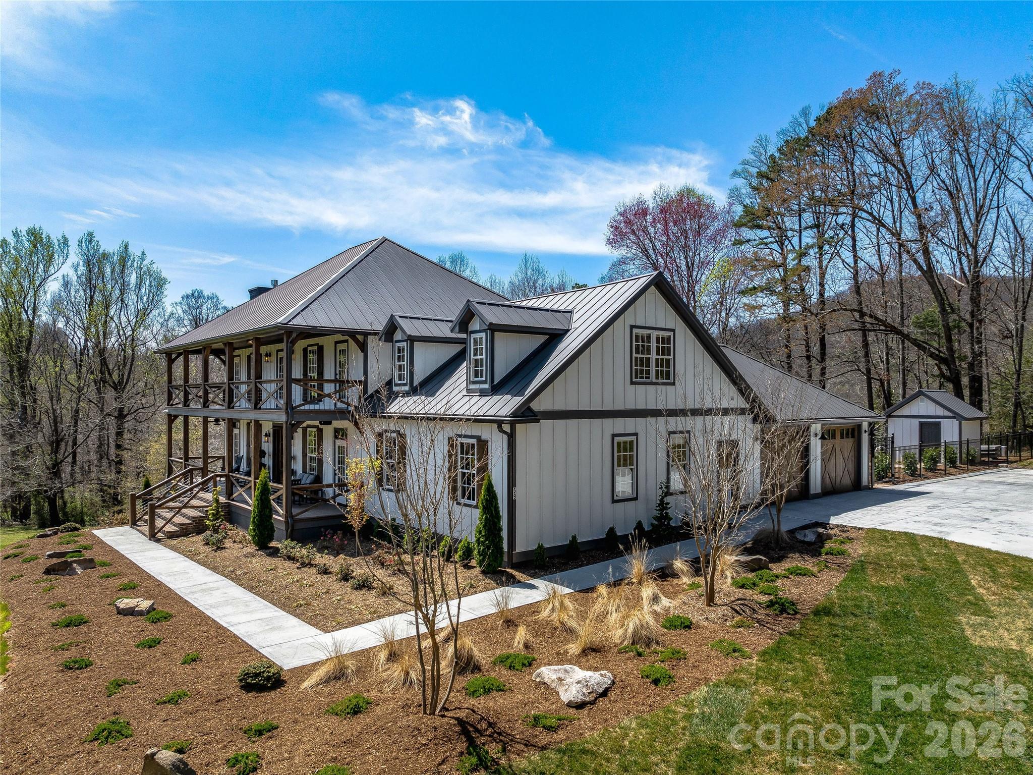 Completely transformed modern farmhouse on 5.5 acres w/ mountain views! This 4BR/3.5BA home features premium designer finishes, top-tier upgrades & $100K+ in smart tech: whole-home audio, Lutron lighting, power shades, security cameras on 4 sides & more. Interior highlights include engineered hardwoods, shiplap, coffered ceilings, soundproof office & living room each w/ gas fireplace plus gourmet kitchen w/ 10' quartzite island, workstation sink & Thermador appliances, including dual-fuel range w/ warming drawer, convection oven. Primary suite has raised ceiling, brick accent wall, & spa-like bath w/ chromotherapy clawfoot tub, heated tile floor, walk-in closet. Backyard oasis touts 18’x38’ heated saltwater gunite pool w/ hot tub, swim jet, Baja shelf, auto cover, smart lighting. Screened porch w/ outdoor TV, EV-ready garage, RV pad w/ 50-amp plug, fully conditioned crawlspace. Turnkey luxury experience convenient to Asheville & Hendersonville amenities. Only 9 minutes to the Asheville airport.