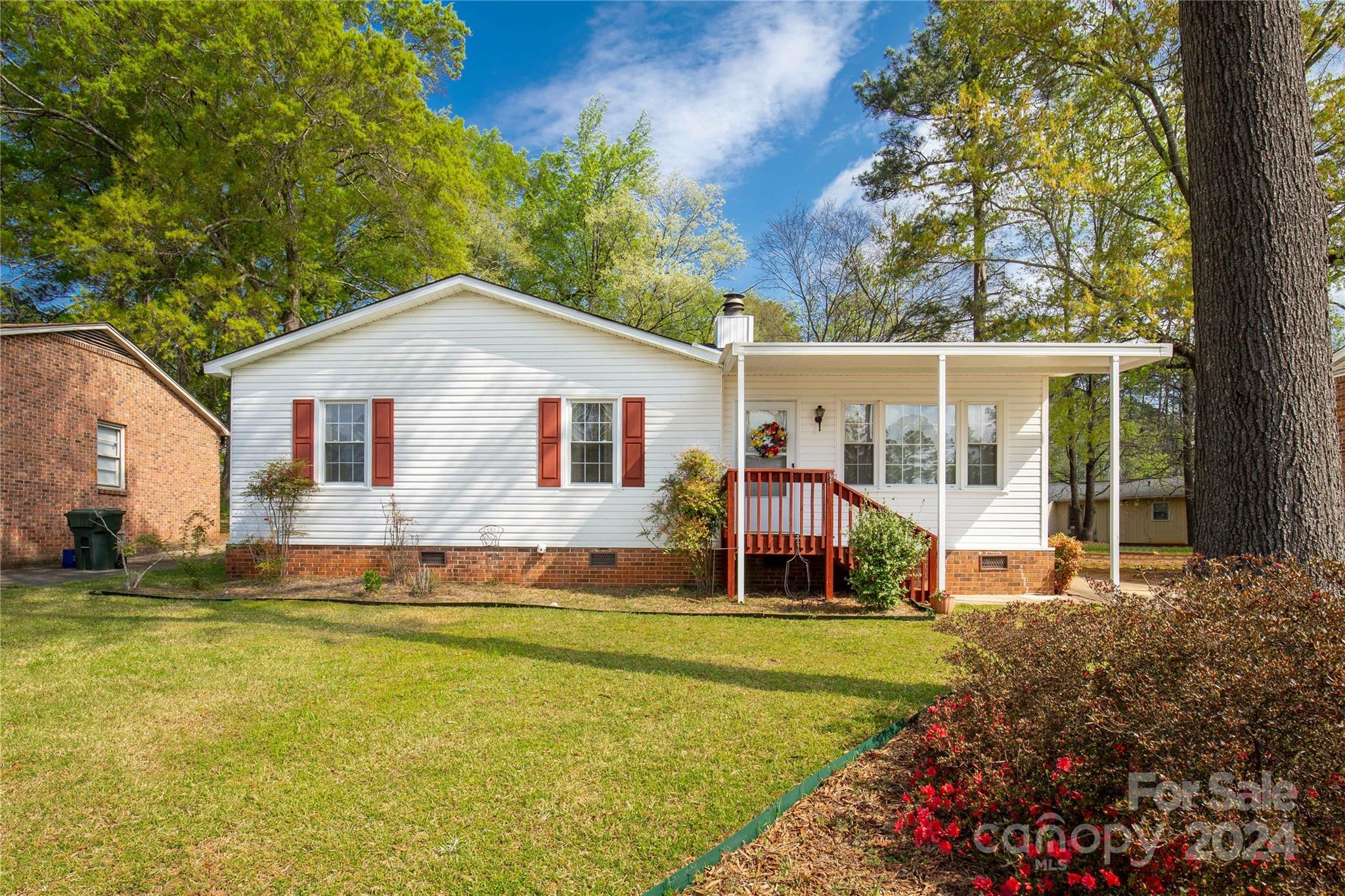 This charming three-bedroom, one-and-a-half-bath home is located in the heart of Rock Hill. The exterior features a wheelchair-access ramp off the driveway, and the roof was recently replaced in 2023, Gas pack HVAC replaced in 2017. As you enter the front foyer area, you'll find a cozy living room/dining area combo centered around a brick fireplace with gas logs. The dining area provides access to a generously sized screened-in rear porch area. The kitchen boasts a double bowl sink with a window overlooking the backyard, as well as a pantry. At the end of the hallway, you'll find the primary bedroom, which features a half bath. The other two bedrooms share a full bath located off the hallway. This home has been lovingly cared for and maintained. Hurry, as this gem surely won't last long!
