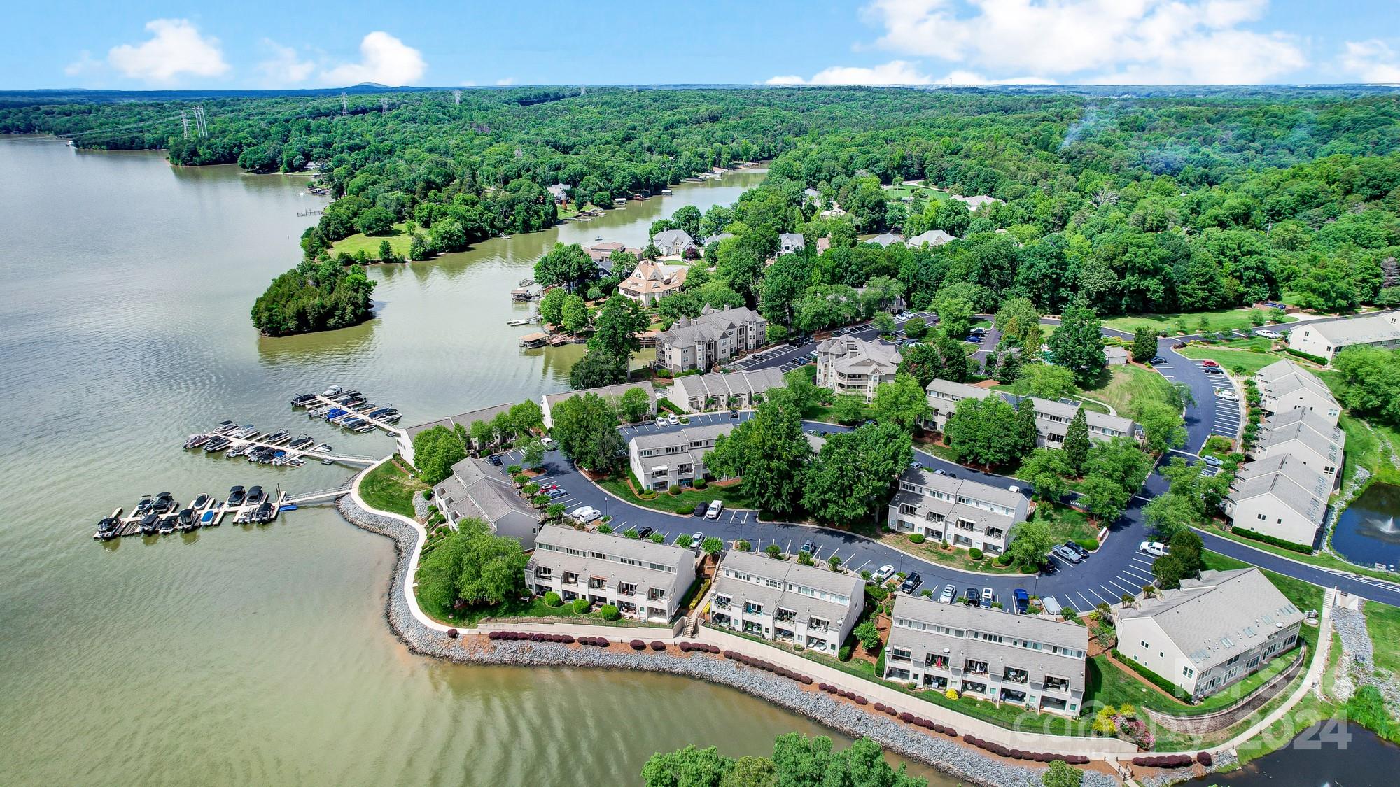 You'll adore the water views and observing the wildlife from your deck and patio areas. This end unit boasts ample natural light streaming in through its many windows. The layout is fantastic, with an open living area and secluded bedrooms. The kitchen features granite countertops and stainless steel appliances. The 3rd bedroom is also a great area being used as a home office with full bath. Rich hardwood flooring is present on the main floor & in the 3rd bedroom/office, while the two lower bedrooms have carpet. Enjoy no outdoor upkeep as the HOA manages lawn care and exterior maintenance. The HOA also organizes enjoyable social gatherings like pool parties, football tailgates, and porch crawls. The gated community adds extra safety, with friendly neighbors & a strong sense of community. Benefit from great amenities including a pool, tennis courts, sandy beach, boat storage, and a beautiful waterfront promenade. Conveniently located near shopping centers, the airport, & major highways.