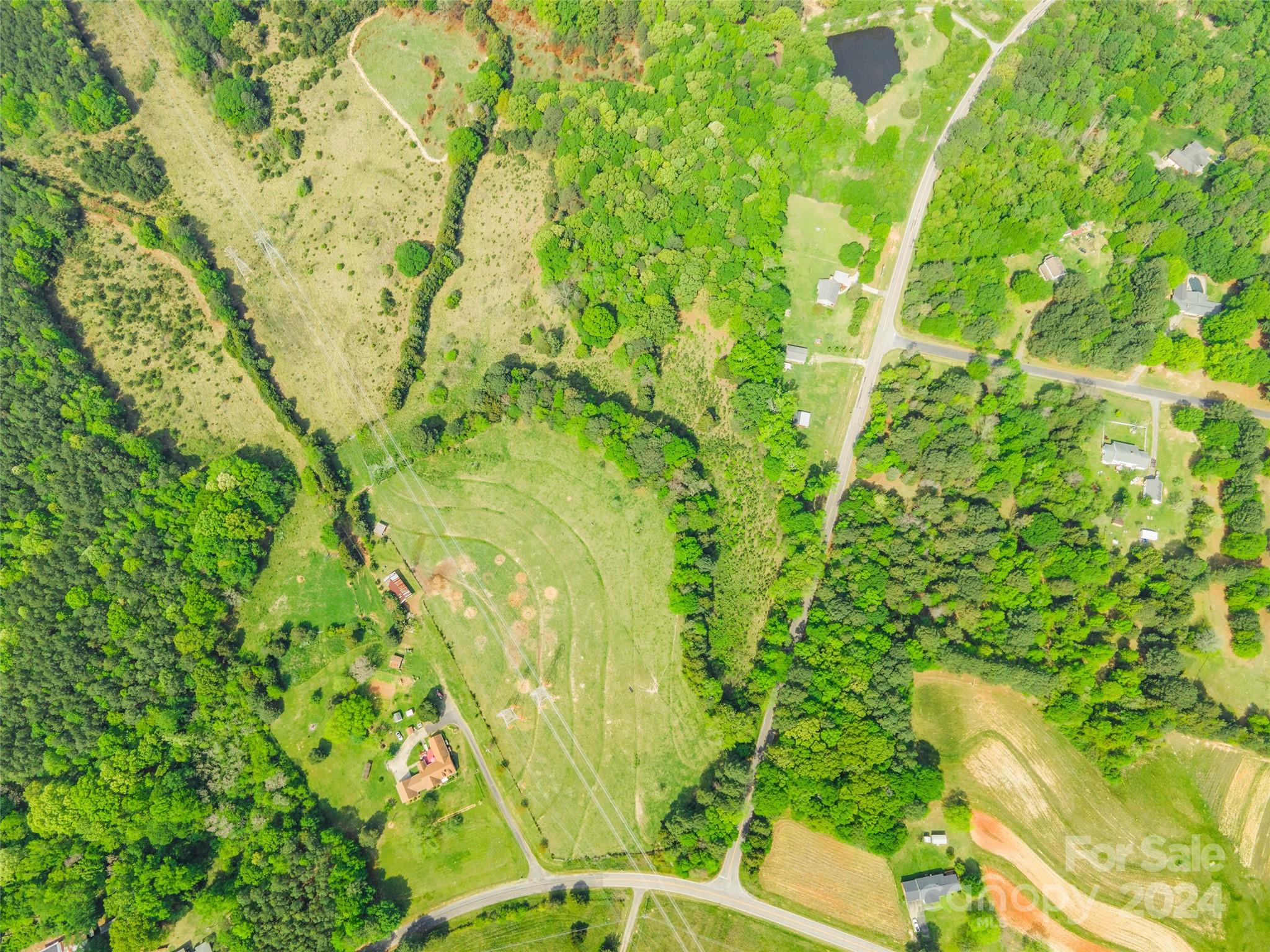 Explore the possibilities with this expansive parcel of vacant land, offering mostly flat terrain and a gated entrance. Perfect for agricultural use or development, this property boasts the charm of farm land with its wide-open spaces and serene surroundings. Whether you're dreaming of starting a new farming venture or envisioning your own custom estate, this land provides a blank canvas for your aspirations. Don't miss this opportunity to make your rural living dreams a reality.