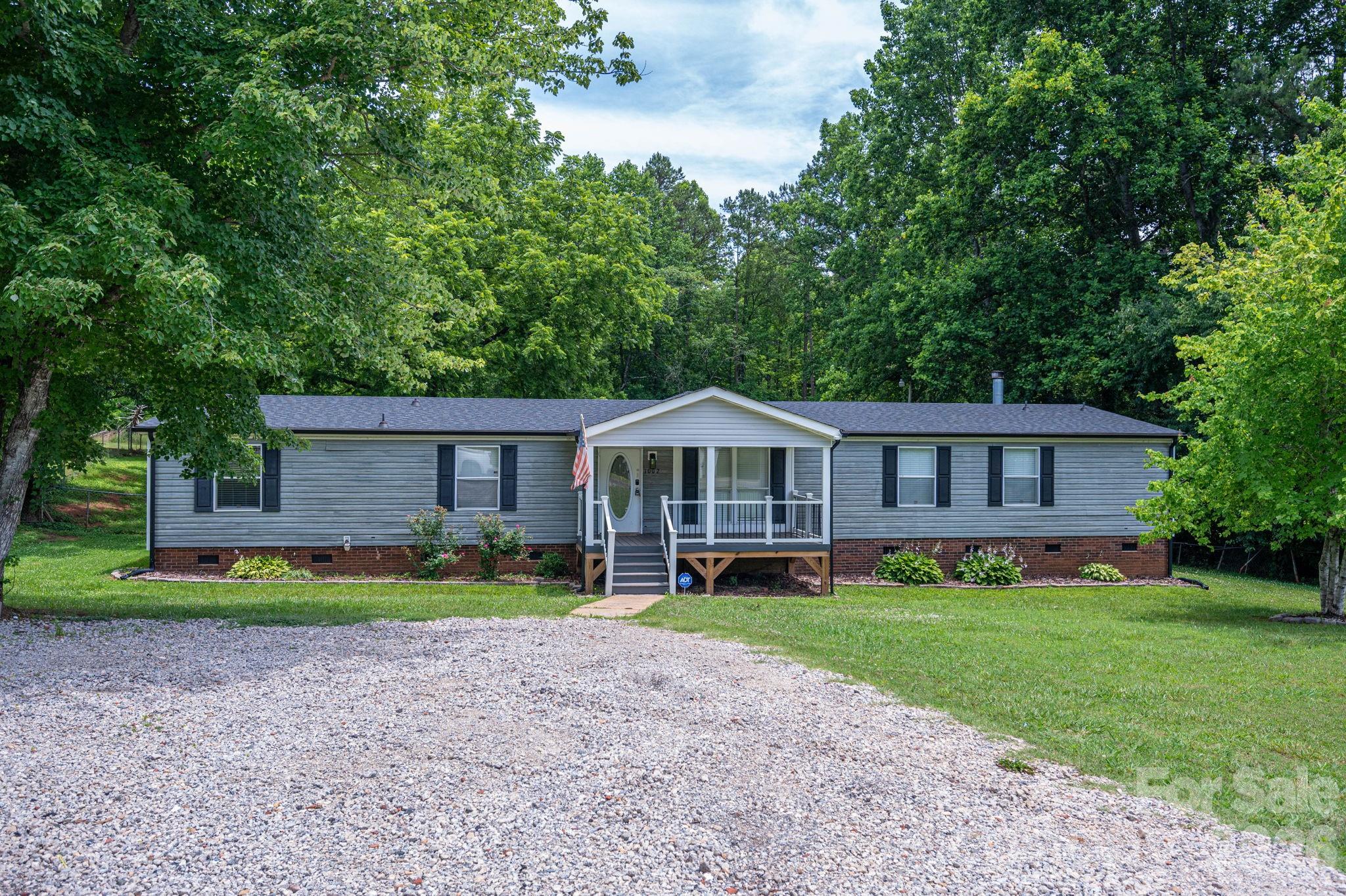 Welcome home to this charming country retreat offering 3 bedrooms, 2 full bathrooms, and a flexible bonus room that could easily serve as a 4th bedroom, home office, or hobby space. The spacious kitchen provides plenty of room for cooking, gathering, and entertaining, while the cozy gas fireplace creates a warm and inviting atmosphere.

Step outside and enjoy peaceful country living from the large covered front porch or relax on the rear deck overlooking the fenced backyard. The property also features a versatile storage building with a garage door, providing excellent space for equipment, tools, hobbies, or additional storage.

Additional highlights include plantation shutters, generous outdoor living areas, and the privacy and tranquility of country living while remaining convenient to nearby amenities. Don't miss this opportunity to enjoy the space, comfort, and flexibility this property has to offer.