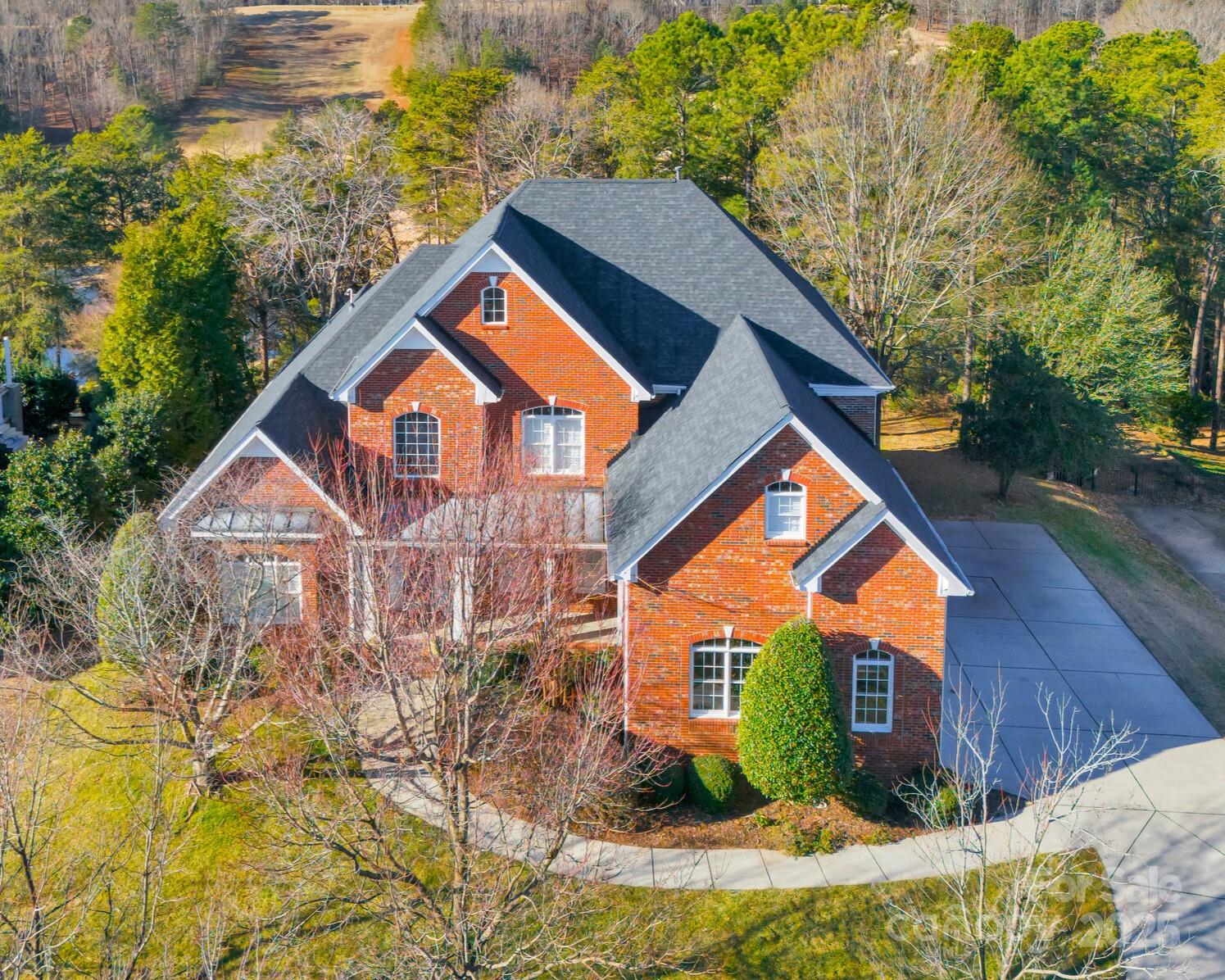 Welcome to this elegant brick home in a prime Tega Cay location, perfectly situated on the 10th hole of the golf course with pond views. The main level features the primary bedroom, an inviting great room with a cozy fireplace, a formal dining room, formal living room, a breakfast area, an office with built-ins, and a utility room. Upstairs, there are three additional bedrooms with 2 full bathrooms, a bonus room and walk-in unfinished storage. In ground Dog fence in backyard, gas grill and fire pit connected to natural gas line. Tega Cay residents have the option to join Tega Cay Golf club with access to golf course, tennis courts and all of the clubs facilities. This home is also zoned for top-rated schools, and close by to many retail and dining options, as well as easy access to I-77, and public boat landing. Don’t miss the opportunity to own this exceptional home in one of Tega Cay’s most desirable locations!