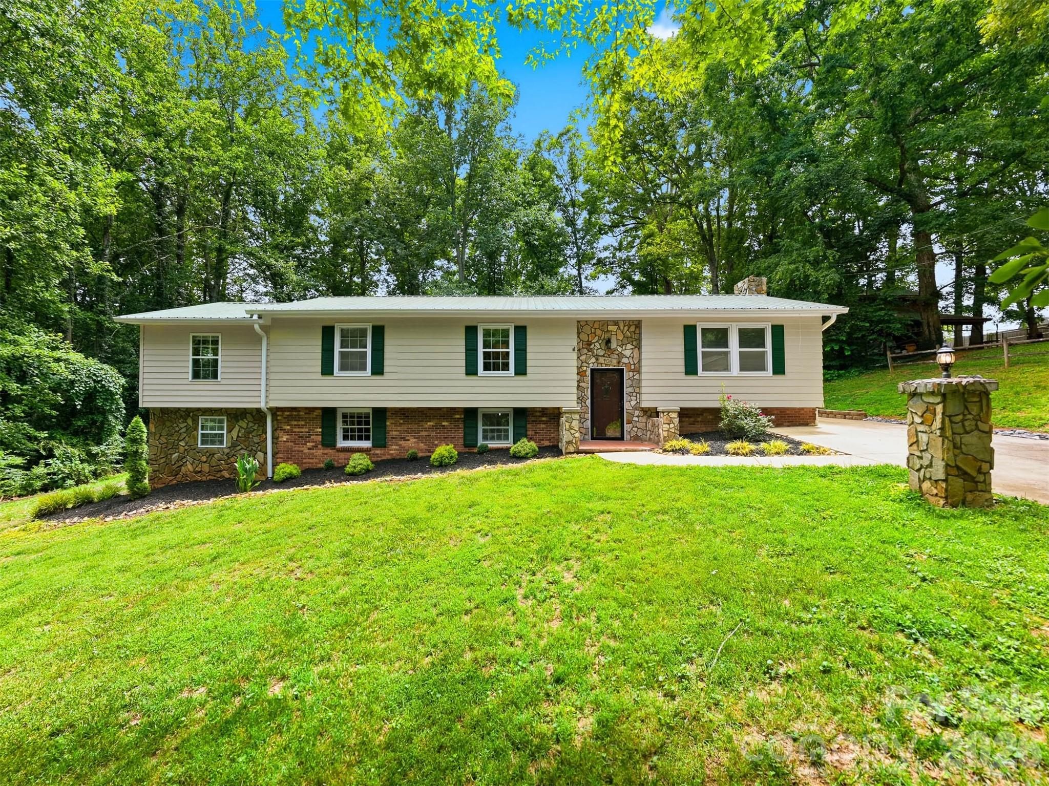 Tucked into a desired Hudson neighborhood, this home is the kind of home buyers wait for. Blending privacy, character, and everyday comfort, this spacious home offers custom touches throughout, beautiful rustic pine board accents throughout the home. Inside a spacious kitchen with upgraded stainless steel appliances, plenty of storage, dining room & living area. Primary bedroom on its own end of the home, offering a privacy complete with access to the screened porch and an updated bath featuring a newly installed walk-in shower. Screened porch overlooks the pool deck, where a pool with a recently installed liner is surrounded by a peaceful, wooded backdrop and plenty of room to relax. Whether you’re enjoying your morning coffee while listening to the birds or winding down on a summer evening, this outdoor living space is designed to be enjoyed year-round. Downstairs, large den area with wood stove and rustic flair, additional room perfect for an office, large storage closet, laundry room & storage space perfect for yard tools and lawnmower. home has been recently updated and freshly painted, 2024 heat pump, and a backyard that feels like a private retreat, this home offers the perfect balance of comfort, charm, and convenience in the heart of Hudson.